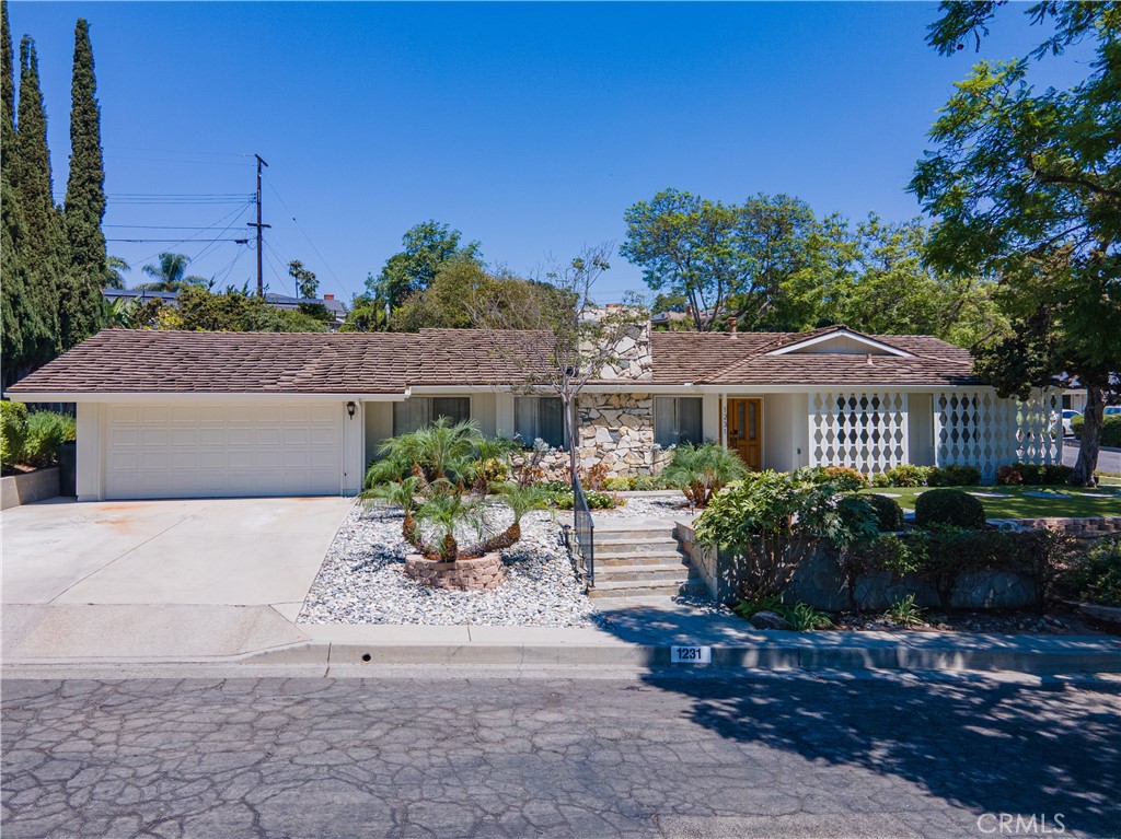 This beautifully maintained and sensational single-story home sits gracefully on a desirable corner lot in a superb neighborhood featuring wonderful curb appeal and fresh exterior paint. Inside, the spacious living and dining areas create a warm welcome, while the in-kitchen breakfast nook is the perfect spot to start your day. The updated bright kitchen is ideal for both everyday meals and special gatherings, offering a pleasant space that makes cooking and conversation a joy. The inviting family room opens through a brand-new sliding door to an incredible backyard retreat complete with a sparkling pool, tranquil waterfall feature, new patio cover and a hidden potting area sure to delight any gardener. Four generously sized bedrooms are tucked along a bright, cheerful hallway, with the primary en suite enjoying its own new slider and serene views of the yard. Lovely wood vinyl flooring flows throughout, complementing the home’s airy layout. The home has a two-car garage, with an EV charger outlet and a terrific workbench area. This home has so many thoughtful updates which makes this property as functional as it is beautiful. From the peaceful outdoor spaces to the comfortable interiors, this is truly a place to call home.