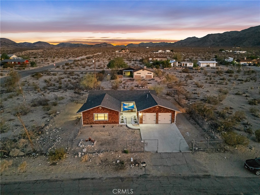 Welcome to your desert dream come true! This beautifully remodeled 4 bedroom 2 bath home offers nearly 2000 square feet of stylish, open-concept living space in the heart of Twentynine Palms. Step inside to discover a bright, modern interior featuring fresh paint, new flooring, updated lighting, and a fully renovated kitchen with sleek countertops and stainless steel appliances. The spacious living room and dinning area flow effortlessly for entertaining or relaxing, while the oversized bedrooms provide comfort and versatility. Both bathrooms have been tastefully upgraded with contemporary finishes. Outside, enjoy desert sunsets from your large lot with plenty of room to expand, garden, or create your own outdoor oasis. Just minutes from local shops, schools, and Joshua Tree National park, this move-in-ready home has newer roof done in 2025, newer AC/heating June 2025 and is the perfect blend of comfort, style, and location. Come see it today and fall in love with Twilight!
