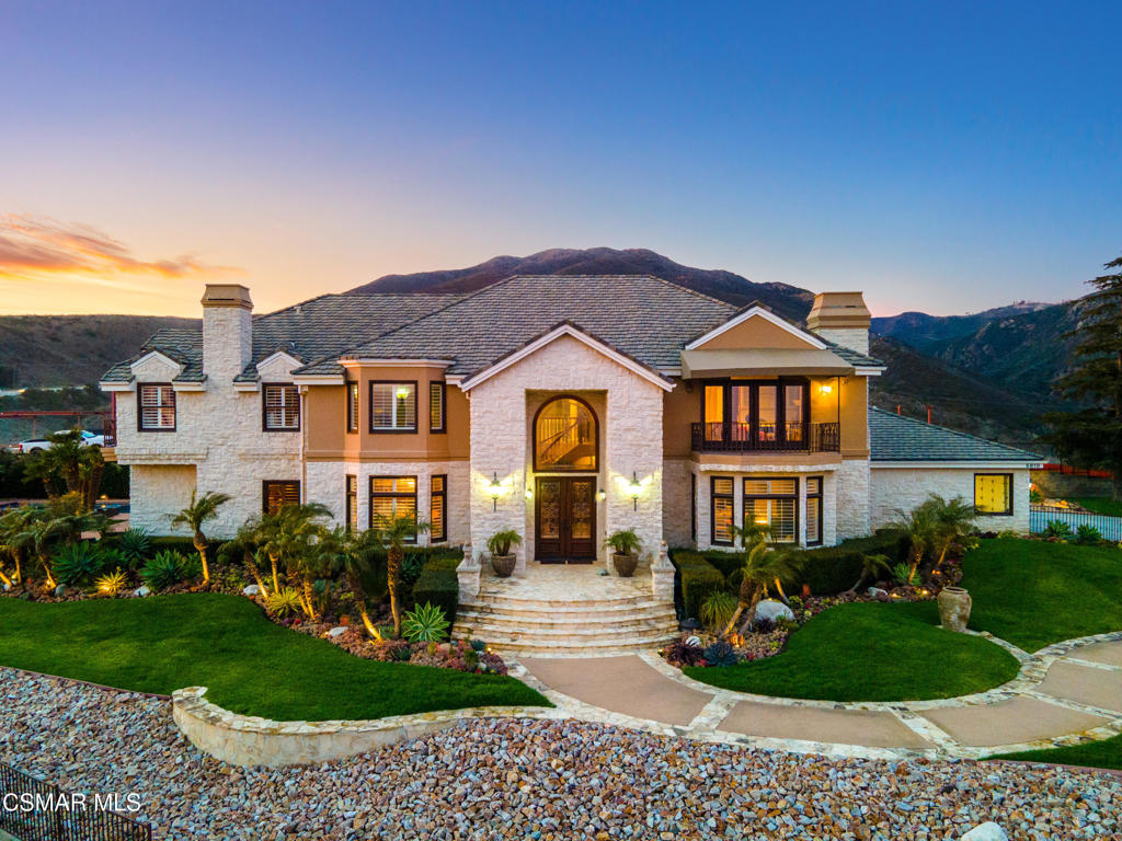 Behind private gates in an exclusive two-home enclave, this 6-bedroom, 6-bathroom view estate offers nearly 6,000 square feet of living space on almost one acre. Located less than a quarter-mile from Pacific Coast Highway, the home combines privacy with easy access to Malibu's beaches, dining, and the Malibu Country Mart. Ocean and sunset views can be enjoyed from most rooms. The entry features a grand double-height foyer with a sweeping staircase leading to light-filled living and dining areas framed by walls of glass. The gourmet kitchen includes custom cabinetry, a large island, high-end appliances, and stylish lighting- ideal for both everyday living and entertaining. A dedicated office and a ground-floor guest suite provide added flexibility. Upstairs, the primary suite includes a spa-like bath, fireplace, and private ocean-view balcony. Four additional bedrooms are spacious and enjoy tranquil views with en-suite or nearby baths. Modern finishes throughout create a warm, sophisticated atmosphere, while gated entry, security cameras, and fire sprinklers provide peace of mind. The outdoor spaces are designed for year-round enjoyment, with a private gas-heated pool and spa, lush lawns, built-in barbecue, and multiple terraces for relaxing or dining with ocean vistas. Mature landscaping and a wrought-iron fence enhance the setting's serenity. A four-car garage and backup generator complete this rare Malibu estate that blends privacy, design, and coastal living.