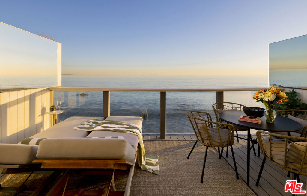 Experience the best of Malibu's oceanfront living in this fully updated top-floor one-bedroom residence, situated directly on the sand at Las Flores Beach.  From the moment you enter, you're greeted by sweeping, unobstructed views of the Santa Monica Bay and a bright coastal atmosphere.  Enjoy private beach access, allowing you to step directly onto the sand for morning surf sessions, sunset strolls, or all-day relaxation by the water.  Inside, the remodeled interior features hardwood flooring throughout, contemporary finishes, dishwasher, and a modern kitchen with custom cabinetry and newer appliances.  A spacious ocean-facing deck includes mirrored accents to reflect the coastline, while the soothing sound of waves below creates a serene backdrop for daily living.  Additional conveniences include two covered parking spaces, offering rare value in this coveted beachfront setting.  Perfectly positioned along Pacific Coast Highway, this location places you minutes from Malibu's world-famous surf breaks, scenic hiking trails, and a curated selection of top restaurants, cafes, and boutiques.  Nobu, Soho House, and Whole Foods are all within a short drive for effortless coastal living.  Relax on your private balcony as vibrant sunsets unfold across the horizon and city lights stretch from Santa Monica to Catalina.  Styled with modern comfort and unmatched access to the shoreline, this coastal retreat offers an extraordinary opportunity to lease true beachfront living in Malibu.  Opportunities like this are rare-secure your oceanfront getaway while it's available.