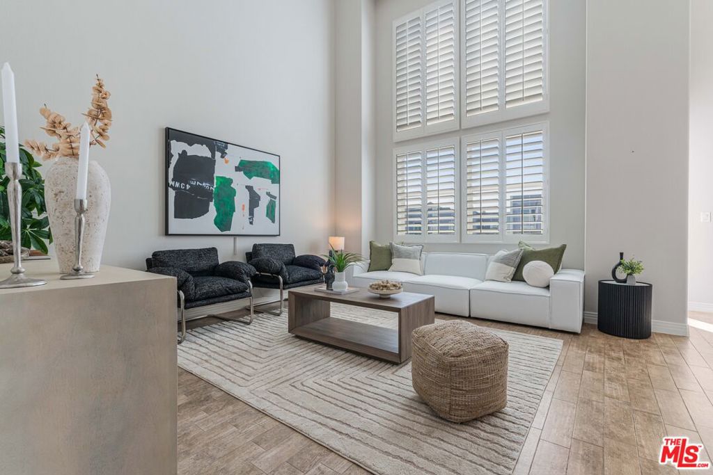 Welcome to this beautifully remodeled top-floor penthouse in the recently updated Coronado building. With nearly 1,900 square feet of light-filled living space, 3 full bedrooms, an office, and 2.5 baths, this home combines modern upgrades with exceptional functionality and style. Step into a grand, open-concept main level featuring soaring 18-foot ceilings and oversized windows that flood the space with natural light. The inviting living room flows seamlessly into a formal dining area and a beautifully updated kitchen, complete with matching stainless steel appliances, newer cabinets and quartz countertops, a generous breakfast bar, and a walk-in pantry. Just off the main living space, you'll find a dedicated office with custom built-ins ideal for working from home, along with a convenient powder room for guests. Upstairs, a versatile bedroom includes its own separate flex space/workout area and a bonus storage room. Downstairs, the expansive primary suite is your private retreat, featuring a walk-in closet and spa-inspired en-suite bath with dual vanities, a soaking tub, and a separate glass-enclosed shower. An additional guest bedroom with ensuite bathroom, and a laundry closet with newer washer and dryer complete the lower level. Additional highlights include two newer HVAC systems for optimal climate control, a south facing balcony, two garage parking spaces with access to EV charging, and a private storage bay. Located just minutes from The Resort, Whole Foods, Runway Playa Vista, Concert Park and top dining spots. This is more than just a home it's a lifestyle. Come experience the vibrancy, convenience, and charm that make Playa Vista one of L.A.'s most sought-after communities.