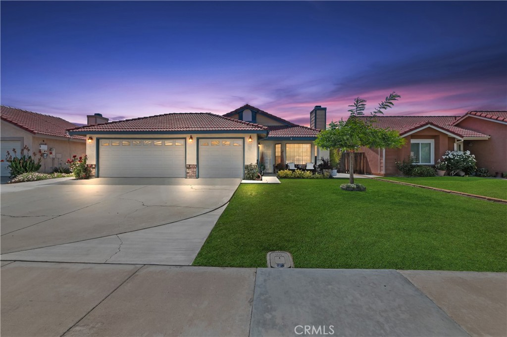 This turn key single-story residence offers a perfect blend of modern elegance and functional design. With 3 spacious bedrooms and 2 bathrooms, this home is ideal for both relaxing and entertaining. There is a light-filled open floor plan featuring vaulted ceilings and a neutral color palette carried throughout the home. The tile fireplace is the focal point of the living room and perfectly complements the sleek, LVP flooring. The heart of the home is the kitchen, which boasts stainless steel appliances, and it opens to a family room/flex space which offers easy access to the backyard. The perfectly sized primary bedroom offers a tranquil retreat with a walk-in closet and in-suite bathroom complete with dual vanity and a tub/shower combo. The additional bedrooms are well-sized, perfect for family, guests, or a home office. Outside, you’ll find a concrete patio, ideal for an outdoor dining space or simply to unwind after a long day. There is also large concrete space in the back waiting to be transformed into your personal oasis. It's a perfect space for an outdoor kitchen! The attached 3-car garage provides ample storage and parking space. This home combines comfort, style, and practicality in a highly desirable location with NO HOA and low taxes. Don’t miss the opportunity to make this exceptional house your new home!
