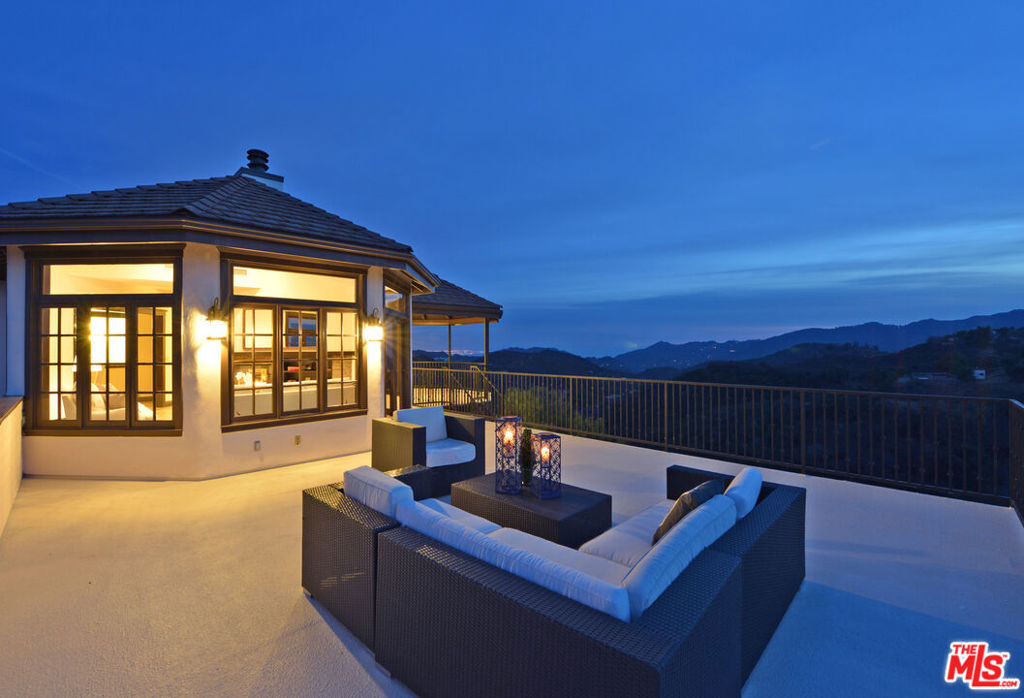 Absolutely stunning Topanga Villa! This luxury property boasts 360-degree panoramic views of the Pacific Ocean, Los Angeles and the Santa Monica Mountains. Completely remodeled, appropriately named Villa Bacchus, for the Roman God of wine and revelry, this sumptuous 3,200+ sq ft, four bedroom, three-and-a-half bath property is designed for you and your family's joy and merriment. The upper level features a private bedroom suite with a gorgeous outdoor veranda and mountain and ocean views along with a custom designed walk-in closet. The luxe bath features a huge soak tub with ceramic Versailles limestone tile & a see-through fireplace also facing the suite. The gourmet kitchen is perfect for entertaining with top-of-the-line appliances, gorgeous custom cabinets, quartz counter-tops, large island & another double fireplace. The elegent dining and living room lead to the dramatic viewing decks just calling for an outdoor spa! The 2nd level family room comes complete with wet bar and also opens to a large view deck. Private entrance to separate suite or office, three car garage and a bonus meditation/workout/yoga room. Jaw-droppingly-beautiful hikes outside your door, a minute's drive to nearby Calabasas and twenty minutes to the beach.