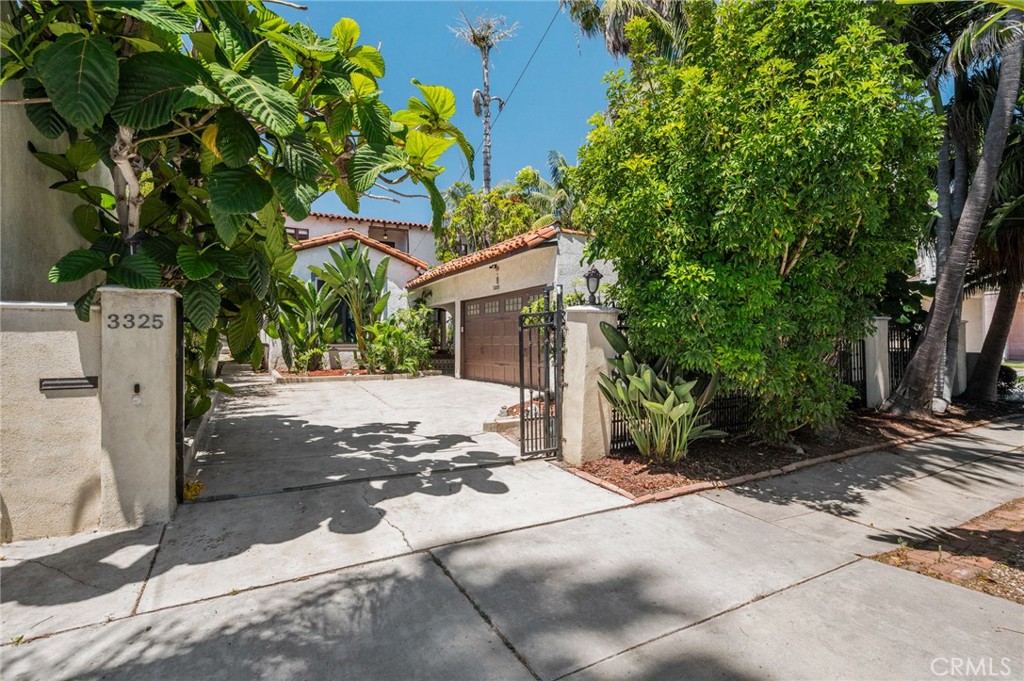 Discover a rare blend of historic charm and thoughtful updates in this 1928 Spanish Revival home, originally constructed for businessman L.C. Busby in the Beverly Hills area and relocated to San Pedro's coastal Point Fermin neighborhood in 1982. Situated on a double lot, this spacious residence retains its original architectural character, including arched doorways, French doors, cathedral-style windows, iron railings, tile accents, and tray ceilings.
The main living area features a dramatic beamed ceiling and large picture window, creating a warm and inviting atmosphere. Original hardwood floors have been professionally restored using era-appropriate materials. The kitchen includes a vintage 1952 Wedgewood stove and red tile flooring, alongside modern appliances such as a Bosch dishwasher and LG refrigerator.
Recent upgrades include a 2023 heat pump offering central heating and cooling, a 200-amp electrical panel with subpanel and EV charging capability, a tankless water heater, and a new roof on the garage (2021). The upstairs bathroom was remodeled in 2025 with Spanish and Brazilian porcelain tile, a 1920s Louis XIV marble vanity, and original 1928 woodwork.
Additional features include a remote-controlled rolling gate, water hookup in the garage, tropical landscaping with 12 palm varieties, cedar-lined closets, and a Jacuzzi tub in the downstairs bath. Enjoy a prime location just blocks from Point Fermin Park, the Angels Gate Cultural Center, Cabrillo Beach, and local favorites like Chachi's Sandwich Shop.
This is a one-of-a-kind opportunity to own a piece of Southern California history with modern comforts in one of San Pedro's most beloved neighborhoods.