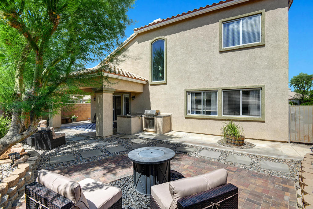 Located in one of Indio's best golf communities, with excellent proximity to La Quinta and Highway 111, this relaxing two-story home on a corner lot boasts 3 bedrooms, 3 baths, with upgraded front and back yard areas. The expansive downstairs includes a half bath, powder room, along with a primary bedroom that offers two spacious walk-in closets, and a bathroom with a standing shower and hot tub. There's ample space and storage throughout the kitchen with gas range, and double ovens. The light and bright living room with fireplace makes for an inviting area to entertain friends and family, only made more comforting with the high ceilings & natural lighting. Upstairs you will find the two well maintained guest bedrooms, with a shared Jack & Jill bathroom, and an office space on the loft. The garage has a Tesla charging station installed as well. Walking distance to the gym and pool around the corner. The 24-hour guard-gated entrance provides welcome peace of mind. Located within the highly regarded Desert Sands Unified School District, this home speaks to families seeking not only a gracious family home but also an exceptional education. Embrace a life where every facet of comfort, leisure, and convenience intertwine to provide a wonderful life experience. HOA includes exterior landscape maintenance, TV, Internet, gym and pool access.