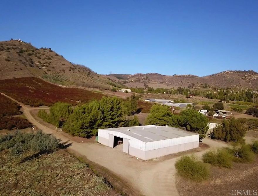 This 205-acre turn-key flower and organic citrus farm offers a great opportunity to own a fully operational, income-producing property in San Diego County best agricultural region. With approximately 125 acres planted in crops—including Organic Eureka lemons, Safari Sunset, eucalyptus, and hybrid waxflower—the farm is very productive with diverse crops.  The property features fencing and gated access, internal road system with culverts and access roads throughout the planted areas. Water resources, with six wells, three municipal water meters, an on-site reservoir equipped with a fertilizer-injector system, and a sulfur burner to manage the PH in the water.  Large Barn with a 1-bedroom apartment inside.