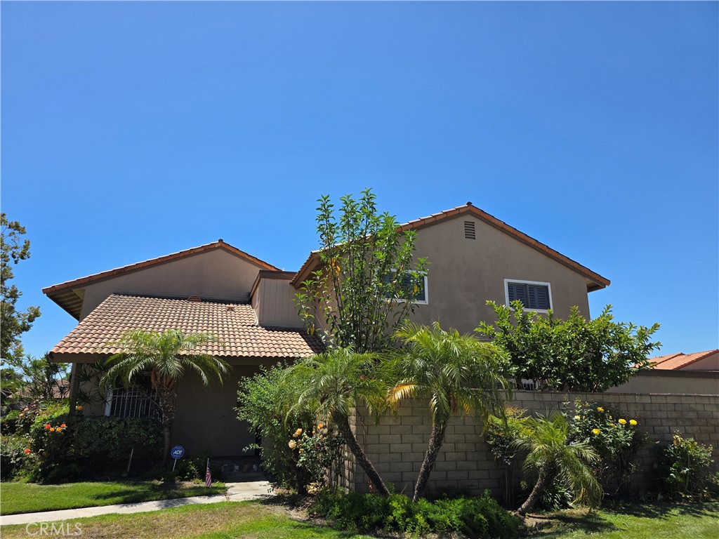 Welcome home!!! Rarely offered on the market!! "Summertree Stanton Community"! Charming corner end unit light & bright 4 bedroom, 2 bathroom, 2 car garage Townhome. This property features a large spacious downstairs primary bedroom and bathroom. Spacious living room which is open to the dining area and kitchen. Featuring upgraded Stainless steel appliances, lots of cabinet and granite counter top space. Upstairs you will find 3 more bedrooms and an upgraded full bathroom. Additionally featuring direct access from the garage, ceiling fans throughout, plantation wood shutter's, Upgraded dual pane vinyl windows, and lots of closet and storage space. Lastly a large spacious private covered patio area. Great for entertaining or to sit back relax and enjoy! This community features many amenities, Pool area, Remodeled club house, Children's playground area, lots of guest parking, and beautifully landscaped tree lined greenbelts for a park like setting. Conveniently located near neighborhood shopping center's, restaurant's and Stanton Central Park. Don't miss out on this one!