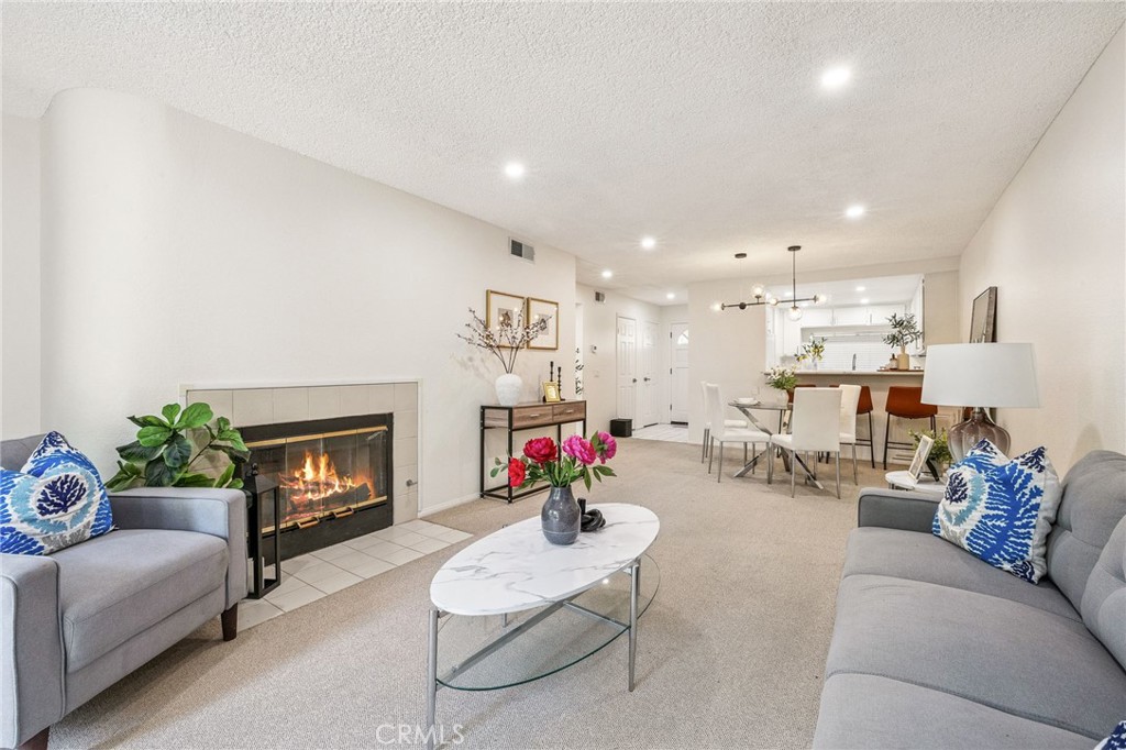 Welcome home to 1418 Brett Place #121! This sunny open condo has 1 bedroom and 1 large bathroom with a tub and separate shower. The newly remodeled kitchen with a large garden window overlooking the lush courtyard garden and a breakfast bar which opens to the dining area and living room. The kitchen features formica counters, refrigerator, gas range and oven. The bedroom has mirrored closets and built in shelving for extra storage. There is an indoor laundry closet with included washer and dryer units. The unit has A/C and heater. The garage has two parking spaces that are side by side in a security gated underground parking garage with remotes. Also included is an outdoor storage closet just steps from the front door. This community features lovely walking paths along beautiful lush landscaping with mature trees, water features, streams with a swimming pool and spa. This building features a gated entrance and an elevator from the garage. HOA dues include water and trash. The community is conveniently located near shopping and restaurants.