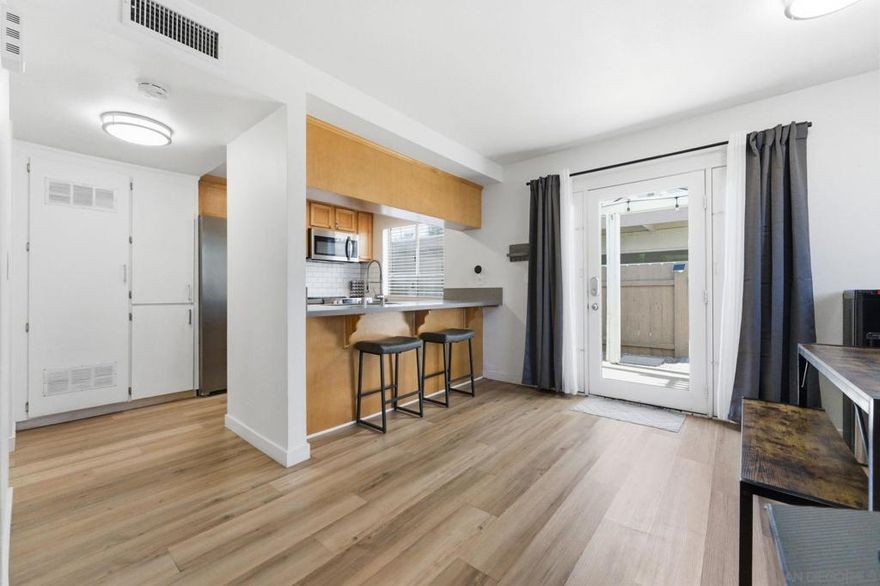 STUNNING TURN-KEY TOWNHOME W/ PRIVATE PATIO, DUAL BALCONIES 2 PARKING SPACES!  Welcome to 11941 Royal Rd #A, light-filled, fully upgraded showstopper that blends modern style, comfort, and prime convenience into one irresistible package. From the moment you walk in, you’re greeted by wide plank flooring, designer lighting, and a bright, airy living space perfect for entertaining or relaxing in style.  The sleek, contemporary kitchen is packed with stainless steel appliances, modern cabinetry, gorgeous countertops, and a breakfast bar that flows effortlessly into the dining and living areas, perfect for hosting friends, game nights, or quiet mornings at home.  Enjoy easy access to your private outdoor oasis featuring a covered pergola-style patio, ideal for grilling, entertaining, or unwinding under the San Diego sky.  Upstairs delivers three oversized bedrooms with plush carpeting and 2 private balcony access, creating true retreat-style living. Both bathrooms have been beautifully remodeled with modern vanities, upgraded fixtures, and elegant tile finishes. Add in central A/C & heat, in-unit laundry, 2 assigned covered parking, storage shed and a well-maintained community, and you’ve got the full lifestyle package.  Located minutes from shopping, dining, schools, and freeway access, this home checks every box!