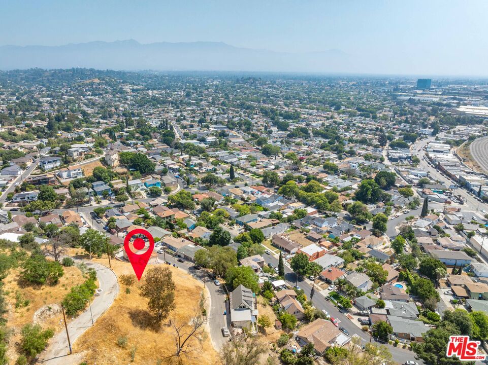 Discover a rare opportunity to build your dream project in the heart of El Sereno. Located on an 5,713-square-foot lot, 2808 Adkins Ave offers commanding views of the San Gabriel Valley and a quiet residential street with easy access to city conveniences. The lot sits above street level, creating the perfect setting for a custom home with a unique hillside design. Newly constructed homes just blocks away, this area is seeing a surge in buyer interest and long-term value. Potential utilities available at the street and favorable zoning, the groundwork is already laid for your vision to take shape. Whether you're an investor, developer, or owner-user, this lot presents an exciting opportunity to create something exceptional in one of Northeast LA's most promising pockets. Outdoor enthusiasts will love being minutes from Ascot Hills Park, a sprawling 93-acre nature preserve with hiking trails and sweeping views of Downtown LA. The nearby El Sereno Recreation Center adds to the neighborhood's charm, offering green space, sports facilities, and year-round community programming. Local flavor and culture thrive just around the corner. Grab a coffee at the beloved Holy Grounds Coffee & Tea, a charming local caf tucked into a peaceful garden setting. Craving something unique for dinner? Head to Zula Ethiopian & Eritrean Restaurant for rich, authentic flavors or explore more dining options just a few miles west in Highland Park and along Adams Blvd, where culinary creativity meets laid-back LA vibes. Families will appreciate proximity to Sierra Park Elementary, El Sereno Middle School, and Wilson High School, while commuters will enjoy easy access to major freeways connecting you to Downtown LA, Pasadena, and the surrounding areas. With limited hillside inventory and a growing spotlight on El Sereno, this lot offers the rare chance to build something personal and profitable. Whether you envision a serene architectural retreat or a smart investment project, 2808 Adkins Ave delivers the location, topography, and potential to bring your vision to life.