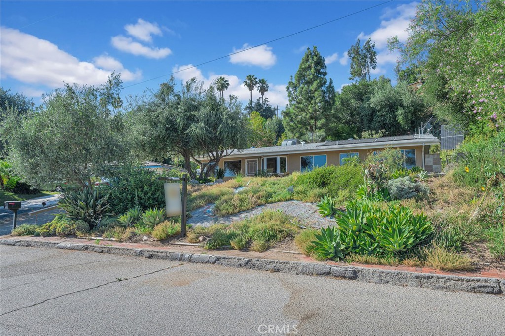 Charming Single-Story Pool Home with Modern Upgrades, Off-Grid Solar, Tankless Water Heater, Dual Pane Windows & Enchanting Gardens!
Nestled at the foothill of a picturesque mountain in one of San Bernardino’s most desirable neighborhoods, this beautifully updated single-story home is a true gem. Offering 3 bedrooms, 2 bathrooms, plus a versatile bonus/flex room—perfect as a home office, gym, or guest space—this 1,243 sq ft home sits on an expansive 13,200 sq ft lot, blending classic mid-century character with thoughtful modern upgrades.
Step inside to discover brand-new flooring throughout, fresh interior paint, updated baseboards, stylish new cabinetry, and energy-efficient dual pane windows that enhance comfort and help reduce utility costs. The kitchen features a sleek quartz countertop and a microwave convection oven combo, while both bathrooms have been tastefully remodeled with new vanities and elegant granite countertops, giving the home a fresh and modern feel. The open living spaces flow seamlessly to your private backyard oasis—reminiscent of an enchanted forest—perfect for relaxing or entertaining by the solar-heated saltwater pool under the mountain backdrop.
Enjoy the benefits of an off-grid solar system, a tankless water heater, a whole-house Halo reverse osmosis water system, and a two-car detached garage offering extra storage or potential workshop space. An automated drip irrigation system in the front yard helps maintain the drought-tolerant landscaping with ease.
Outside, the front yard is a horticulturist’s dream—filled with drought-tolerant plants that attract butterflies, hummingbirds, and songbirds, creating a peaceful, vibrant habitat right at your doorstep. The oversized lot offers endless opportunities for gardening, play areas, or future expansions—plenty of room to bring your vision to life.
A detached garage makes this home have immediate ADU potential should you desire it!
Located in a low-tax area, and no HOA, this home combines sustainable living, modern comforts, and a magical outdoor retreat—all in a sought-after neighborhood near scenic mountain views. Don’t miss this unique opportunity—schedule your private tour today!