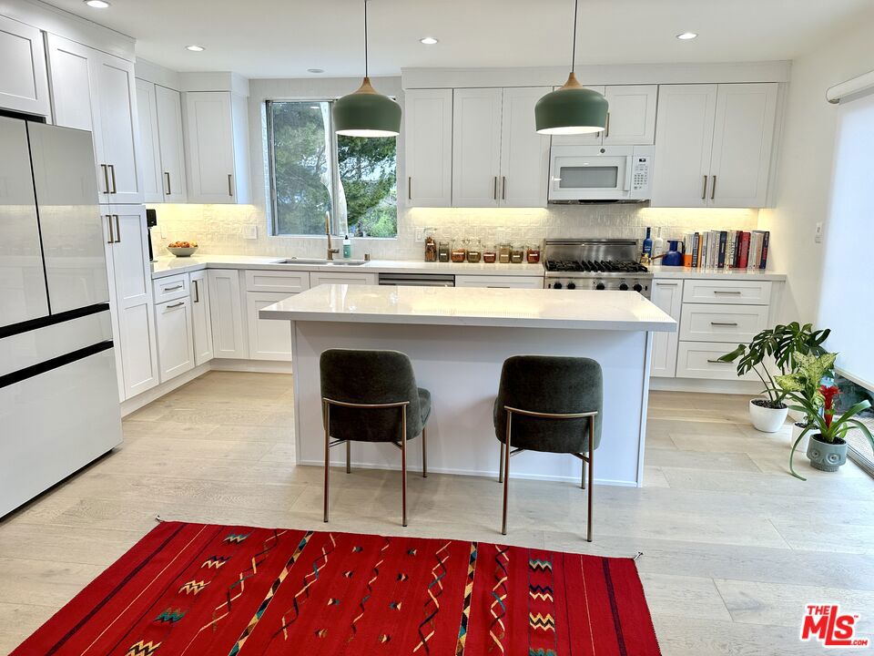Located in the heart of Ocean Park, this stylishly updated 3-bedroom, 2-bathroom condo offers the perfect blend of beachside charm and modern comfort. The lower level features an open-concept living and dining area, a recently renovated kitchen with sleek finishes, a full bathroom, and a versatile bedroom- ideal as a guest suite, office, or den. Just off the kitchen and dining area, a private balcony offers a quiet outdoor space to relax and enjoy the views. Upstairs, you'll find two bright bedrooms, a full bathroom, and convenient in-unit laundry. With two dedicated parking spaces and easy access to Main Street, Rose Avenue, and the beach, this is Santa Monica living at its best.