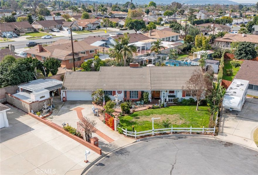 This charming home is tucked away in a peaceful cul-de-sac in the heart of West Covina. Behind the large iron gate on the left, you’ll find a generous space in front of the garage—perfect for accommodating multiple family cars. Inside, the popular three-bedroom, two-bath layout offers both comfort and functionality, enhanced by newer double-paned windows throughout. The spacious living room offers a warm welcome, while the kitchen conveniently opens to both the dining area and a cozy breakfast nook. A large family room flows seamlessly into a bright sunroom (extra space not included in the listed size)—ideal for a home office, playroom, or entertainment space. The master bedroom opens onto a wide patio that extends into the expansive backyard.  Set on a flat 14,743-square-foot lot, the property is filled with abundant fruit trees, making the outdoor space truly special. Conveniently located near the 10 Freeway, shopping centers, highly rated schools, and a variety of restaurants, this is a must-see home that offers both tranquility and everyday convenience.