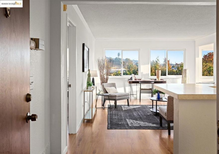 Why rent when you can buy! Large second-floor corner unit, open floor plan, kitchen opens to comfortable living room, perfect for entertaining. Large windows surround the interior, drenched in sunlight during the day easing into a sunset view from the dining area as evening approaches.  Dual primary suite configuration offering ideal separation of spaces for occupants. Laminate floors in the living/dining and bedrooms. The bathrooms have separate vanities, shower over tubs, new vanity light fixtures, (2025). This unit has sizeable bedrooms with large windows. Convenient in-unit washer and dryer, detached 1-car garage parking, and an additional assigned parking place with the unit number.   The association has a clubhouse and pool, as well as an area with barbecue grills for outside gatherings. Close proximity to several shopping plazas, one conveniently located right across the street. Easy access to Highway 80 and public transportation.