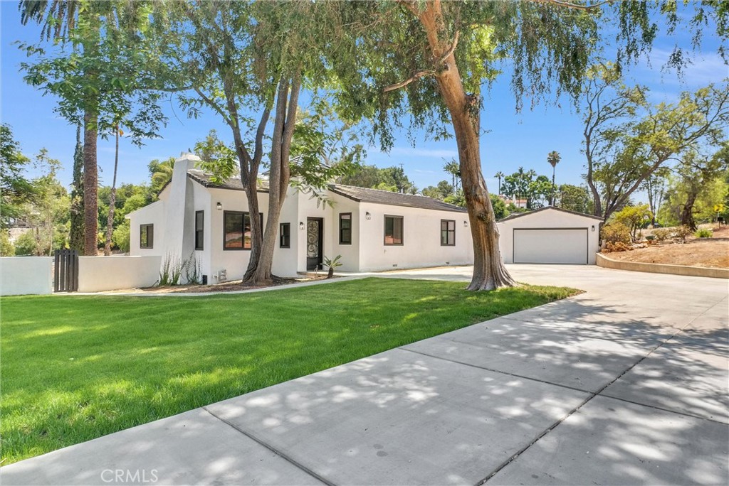 Stunning Renovated Estate with Guest House, Pool, Pool House & Prime Riverside Location
Welcome to your dream home! This beautifully renovated estate in one of Riverside’s most sought-after neighborhoods offers luxury living with room to relax, entertain, and grow. Sitting on a generous 0.8-acre lot, this turnkey property features a fully upgraded 4-bedroom, 3-bath main house, a spacious 1-bedroom, 1-bath guest house with private laundry, in-ground pool and a charming pool house complete with a cozy fireplace that can be converted to a 2nd guest house/ADU.
Step into the 1,976 sq. ft. main residence, where modern elegance meets everyday comfort. The heart of the home is the gourmet kitchen, outfitted with high-end stainless steel appliances, custom cabinetry, quartz countertops, and a sleek island — perfect for hosting or enjoying a quiet morning coffee. The open floor plan seamlessly connects the kitchen to the living and dining areas, filled with natural light from brand-new windows and finished with designer flooring and fresh paint throughout.
Retreat to beautifully upgraded bathrooms with contemporary finishes, and enjoy peace of mind with major updates including a new roof, drywall, windows, flooring, and interior/exterior paint. An automatic sprinkler system keeps the landscaping lush year-round.
The detached 550 sq. ft. guest house is ideal for multigenerational living, rental income, or extended stays, offering complete privacy and its own laundry area. The pool house, featuring a fireplace, adds a perfect bonus space for entertaining or unwinding after a swim.
Outside, the sparkling swimming pool sets the scene for summer fun, all framed by the large backyard that offers endless possibilities for outdoor living and expansion.
Located just minutes from Downtown Riverside, UC Riverside, and California Baptist University, this home combines the convenience of city access with the tranquility of a well-established neighborhood.