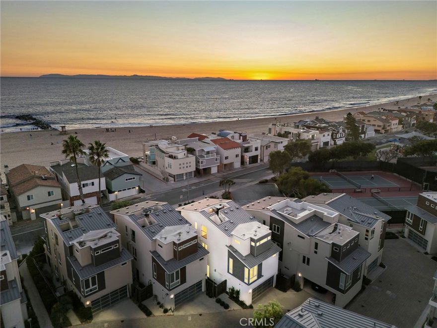 Just across the street from the sand and surf, this bright, fully detached coastal haven in the sought-after “Echo 56” enclave embodies the very best of seaside living, where the rhythm of the waves and the scent of salt air become part of everyday life. In a premier location within the community, this home commands attention with big ocean and Catalina views from the rooftop deck and upper levels, offering an ever-changing canvas of sea and sky that soothes the senses. Inside, the residence radiates modern sophistication and coastal warmth. The interiors are bathed in natural light, enhanced by artisan tilework, wood flooring, and designer finishes that elevate every detail. The gourmet kitchen is an entertainer’s dream, anchored by a large island with bar seating, a Wolf range, Sub-Zero refrigerator, custom cabinetry, and statement tile that blends artistry with function. The thoughtful architecture and open floor plan create a rare sense of privacy and tranquility, while still maintaining a continual connection to the outdoors. A rooftop deck, terraces, and private patio spaces open to soothing ocean breezes, creating ideal spaces for morning coffee, sunset gatherings, or starlit evenings overlooking the Pacific. The vast primary suite occupies an entire level of luxury; its own serene sanctuary with a direct ocean view balcony, dual walk-in closets, built-ins, and a spa-inspired bath that invites relaxation at every turn. Two additional bedrooms and a flexible bonus room for an office, gym, or creative studio add versatility and convenience for guests or family. A private rooftop deck with panoramic 360-degree views crowns the home, offering a front-row seat to endless sunsets and coastal serenity. Just steps from the sand and only a short bike ride to world-class dining and boutique shopping, this residence captures the effortless elegance of coastal Orange County living in an easily accessible location. Here, every day feels like a retreat; modern, bright, and perfectly balanced between luxury and ease.