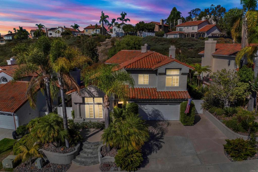 This just may be one of the most beautiful homes in the highly sought after Ocean Terrace neighborhood! Welcome to your new home where tranquility meets timeless elegance! Step into the lush, Zen-inspired backyard and let the soothing sounds of the three-tier koi pond and refreshing ocean breezes melt your stress away! Inside, this meticulously maintained home has been richly and extensively updated throughout. Sunlight fills every room, showcasing luxury vinyl plank flooring, plush high-end carpeting, and stylish fixtures. The gourmet kitchen is a chef’s dream with newer cabinetry, fabulously unique granite countertops, a commercial-style six-burner range, and a striking copper tile backsplash. Entertain with ease in the formal living and dining rooms, or relax in the open family room—complete with one of the home’s three stunning fireplaces! The romantic primary suite features its own fireplace, an ultra modern freestanding soaking tub, dual vanities, an awe inspiring walk-in shower, a spacious walk-in closet, and a sunny private balcony too! Out back, enjoy a true tropical oasis! The secluded yard is fully fenced and filled with mature trees, palms, and vibrant, exquisite landscaping! Multiple patio areas, a shady pergola, and a built-in barbecue with an outdoor fireplace create the perfect setting for gatherings or quiet relaxation. All of this, just minutes from sandy beaches, Calavera Preserve’s scenic hiking trails right outside your door, plus world-class dining, shopping, golf, and more. This stunning home is truly move-in ready...nothing to do but unpack and fall in love!