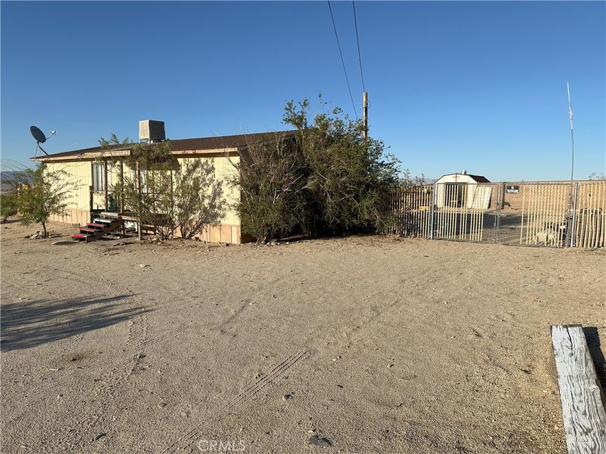 This Home on Spacious 4.14 ACRE lot ZONED RS-4,  2 Bed 2 Bath home with an additional multi use room, office/3rd bedroom/nursery. PAVED streets and Unobstructed Panoramic Breath Taking views, that join you with Beautiful sunrises and sunsets every day forever. A short drive to town for all your daily necessities.  This home is joined on this extremely large lot ZONED RS-4 is unique in the area and is highly sought after real estate with untapped potential. The picturesque mountains and valley bring a serene atmosphere to your home and with a little imagination can make dreams come true. Investors, energetic contractors and home buyers welcome, a little TLC will be needed for updating. Seller will not be making any repairs to close escrow and is being sold AS-IS . The potential that  this property brings will move fast.  Outdoor storage sheds storage area behind the home.