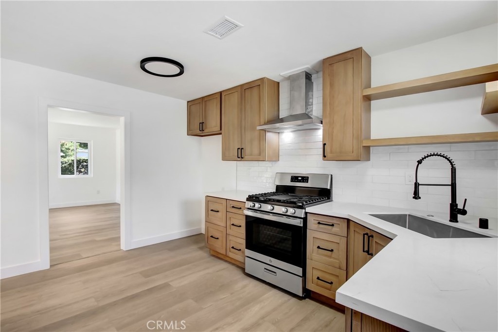 Step into comfort and charm with this beautifully remodeled 3-bedroom home in the heart of Banning! From the moment you walk in, you’ll be greeted by wide plank flooring that flows effortlessly throughout the space, creating a cohesive and inviting atmosphere.
The kitchen is a showstopper, featuring warm-tone cabinetry, modern wood shelving, and crisp white quartz countertops. Brand new stainless steel appliances and a sleek range hood —perfect for both everyday living and entertaining.
Enjoy the convenience of an indoor laundry room, and stretch out in three spacious bedrooms filled with natural light. Step out back to find two large storage sheds—ideal for tools, hobbies, or keeping your gear organized.
Whether you're a first-time buyer, downsizing, or simply searching for that ideal blend of style and practicality, this gem checks all the boxes. Don’t miss your opportunity to own this turnkey beauty—schedule your tour today!
