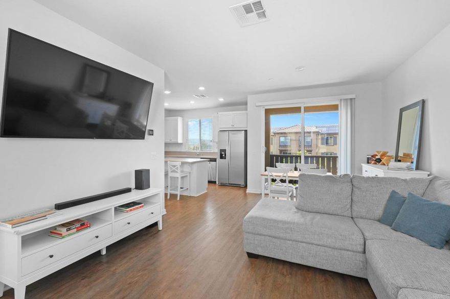 Welcome to the Mission Villas Community of San Marcos.  Built in 2017, this "like new" unit is laid out like a townhouse (no one above or below) with a 2 car attached garage.  The unit is located in the end building which allows for ample natural light to beam through windows on both sides.  The main floor features luxury vinyl plank flooring, a 1/2 bath for guests, a dining area, and private balcony for additional living space.  The modern kitchen has shaker cabinets, stone countertops and stainless steel appliances.  Upstairs you'll find a full size laundry closet and two generous sized bedrooms each with their own ensuite bathroom.  With easy freeway access, close to local shopping and eateries and less than 2 miles from CSUSM, the location is ideal.
