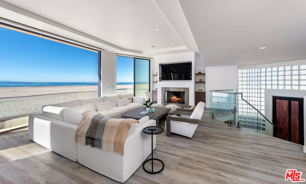 Step inside Hollywood Beach's finest residence. Completely renovated recently, this quintessential four bedroom three bath beach home is situated on a rare corner lot with only one neighbor on its left and an open body of sand to its right, providing further privacy and offering additional sunlight to light up the home's interior. This home features it all - floor to ceiling sliding pocket doors to take advantage of the indoor/outdoor lifestyle and ocean breeze, panoramic views of the coastline and breathtaking sunsets, new hardwood floors, and furnished with high-end Restoration Hardware furniture and more throughout. Perfect for entertaining - the living room is an open floorplan from the ocean deck, to the wet bar with Miele expresso machine, to dining table, and kitchen with new Taj Mahal stone countertops, Wolf range, appliances and Sub-Zero refrigerator. The upstairs primary bedroom showcases its own private and expansive ocean front deck, along with a private fireplace for the primary bedroom, large walk-in closet, sitting room and a luxurious primary bath. Downstairs features two additional guest bedrooms, and a tv/game room with a wet bar that opens straight out to a large private deck on the sand. Three car garage with work bench, shelving, two kayaks and two beach cruiser bikes. One block away from the marina, yacht clubs, restaurants and the weekly Sunday farmer's market. 20 minutes to Ojai, 40 minutes to Santa Barbara. Available immediately!