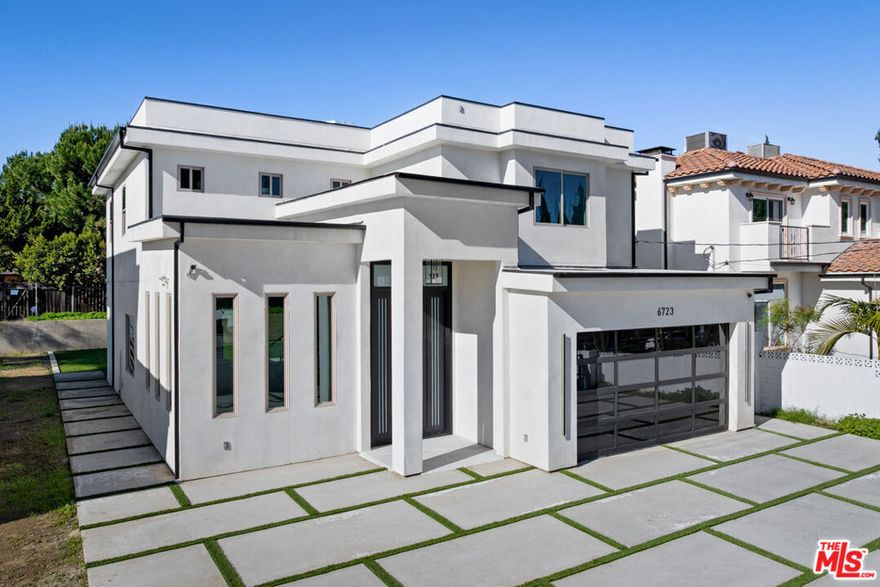 Located in the heart of Valley Glen, this striking 2025 new construction residence showcases contemporary architecture, refined finishes and a thoughtfully designed floor plan. A dramatic entry sets the tone, highlighted by 14-foot ceilings in the living room that create an immediate sense of scale, light, and architectural presence, while the remainder of the first floor offers 10-foot ceilings, enhancing the home's open, airy feel. The open-concept layout flows seamlessly into a sophisticated kitchen featuring sleek modern cabinetry, stainless steel appliances, and generous workspace designed for both entertaining and everyday living. The main level offers exceptional flexibility with two bedrooms, a full bathroom, and an additional powder room, ideal for guests, or a private home office. Upstairs, 9-foot ceilings provide generous volume with three generously sized en-suite bedrooms, each complemented by beautifully finished bathrooms that evoke a spa-like experience. The property is equipped with solar, modern electrical and gas systems, and all-new construction components, offering long-term peace of mind. Clean architectural lines and contemporary finishes complete this turnkey offering. Blending elevated design, modern efficiency, and a prime Valley Glen setting, this home presents a rare opportunity to own a brand-new luxury residence within an established neighborhood.