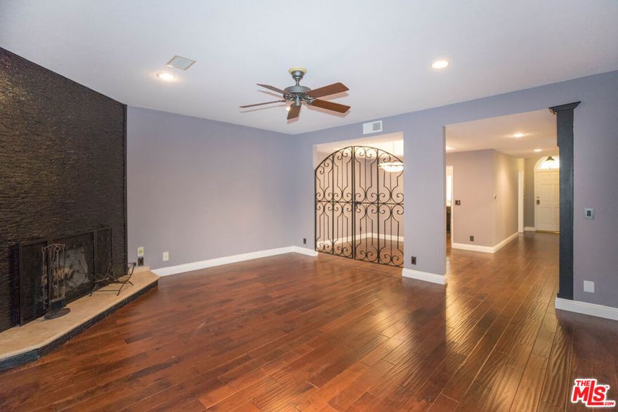 Welcome to this generously sized, beautifully remodeled single-level condo, offering comfort, style, and convenience in a gated complex with top-tier amenities. Formal entryway that leads to a bright and functional kitchen featuring granite countertops, stainless steel appliances, including a refrigerator, stove, dishwasher, and microwave, plus a breakfast bar and casual dining area. A decorative iron gate elegantly separates the formal dining room, which includes a built-in bar and flows seamlessly into the expansive living room. Enjoy cozy evenings by the decorative fireplace or relax on the private balcony. A hallway with two closets, one equipped with a washer and dryer, connects to the spacious bedrooms. The guest bathroom includes a shower/tub combo and additional storage. The luxurious primary suite boasts soaring ceilings, a ceiling fan, custom built-ins, three walk-in closets, and a spa-inspired en suite bathroom with a modern vanity and light-up mirror. The generously sized second bedroom features mirrored closet doors, large windows, and a ceiling fan. Residents enjoy access to a secure building with resort-style amenities, including a pool, sauna, and gym. The unit includes two side-by-side garage parking spaces. Tenant pays for all utilities except water, trash, and sewer. No pets allowed.