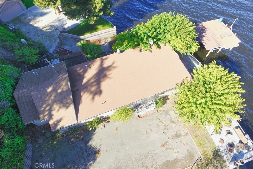 Welcome to your dream waterfront oasis! This exquisite lake property offers unparalleled serenity and endless recreational opportunities. Nestled behind a private gate, this fully fenced haven ensures privacy and security while you soak in stunning panoramic views from every corner.
At the core of this breathtaking estate is direct lake access with your very own dock, perfect for launching your adventures on shimmering waters. For added convenience, you'll find a detached garage complete with a boat ramp, accommodating all your aquatic toys.
This unique property also boasts versatile outbuildings perched above the main living area, an ideal setup for generating rental income or creating separate guest quarters. Whether you’re seeking passive income or space for extended family and friends, possibilities here are truly boundless. plenty of storage with 2 older travel trailers for more storage or maybe guest house with a little work, located at the top of the home. Build in BBQ area, patio, pier and deck.