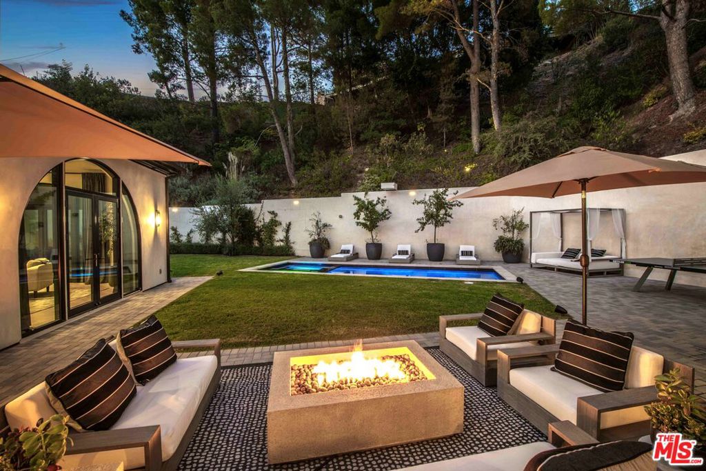 Exceptional 5 bedroom, 5.5 bathroom luxury estate located in the exclusive, guard-gated community of Hidden Valley Estates. This architectural masterpiece offers apx. 6,780 sq.ft. of expertly designed living space on an expansive apx. 1.10 acre lot. Fully remodeled and designer-finished in 2021, every detail has been thoughtfully curated to create a contemporary sanctuary of style and comfort. Inside, an expansive open kitchen and family room provide the perfect setting for modern living and entertaining. The chef's kitchen features top-of-the-line appliances, custom cabinetry, and stunning countertops, while the adjoining family room is bathed in natural light, offering a relaxed yet sophisticated ambiance. Formal living and dining rooms set the stage for elegant gatherings, and a dedicated media/game room with full bar ensures endless opportunities for leisure. The resort-style backyard is a true highlight, boasting a sparkling pool, cozy fire pit, and an outdoor kitchen ideal for dining al fresco. A state-of-the-art outdoor home theater, complete with surround sound, audio, and WiFi capability, creates the perfect venue for movie nights under the stars. Equipped with advanced smart home technology, the residence includes a Clare Home security system with glass-break sensors, Hik-Connect and Ring surveillance cameras with facial recognition and intercom doorbell, and a Lutron home automation system with dimmer switches and customizable lighting. Every element, from the hand-selected materials to the designer lighting, exemplifies refined craftsmanship and modern luxury. With abundant space for both relaxation and entertainment, this remarkable estate offers an unparalleled blend of sophistication, privacy, and comfort.