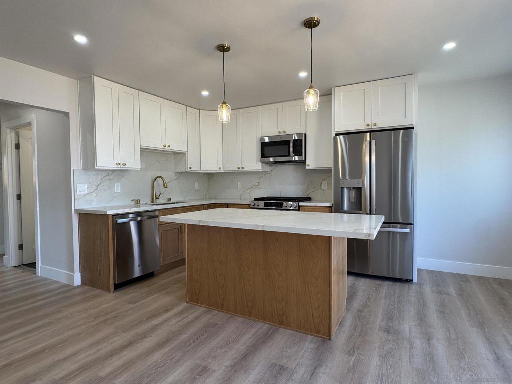 FULLY REMODELED IMPERIAL BEACH HOME — NO HOA, PRIVATE YARD, GARAGE & PARKING! Welcome to 823 Georgia Street, the lowest-priced 2-bedroom home in Imperial Beach with no HOA fees—and absolutely nothing left to do but move in. Fully remodeled from top to bottom, this 2-bedroom, 1-bath stunner offers 845 square feet of modern living, redesigned for comfort, style, and functionality. Step inside to discover a bright open-concept great room that seamlessly connects the living area, dining space, and kitchen. The heart of the home features a large island perfect for prep and casual dining, brand new cabinetry, new appliances, and even an office nook tucked smartly into the kitchen. The home is loaded with upgrades: new windows, new flooring, new kitchen and bath, upgraded electrical—everything is NEW. Both bedrooms are spacious, and the full bath has been completely reimagined with contemporary finishes. You’ll also love the large laundry room with plenty of space for storage or extra functionality. Outside, enjoy your own private front yard and backyard—a rare find at this price point—plus a one-car garage, one-car driveway, and an additional off-street parking space. Whether you’re a first-time buyer or looking for a turnkey coastal investment, this home checks every box—and with no HOA fees, it’s one of the best values in IB. Don’t miss this incredible opportunity!