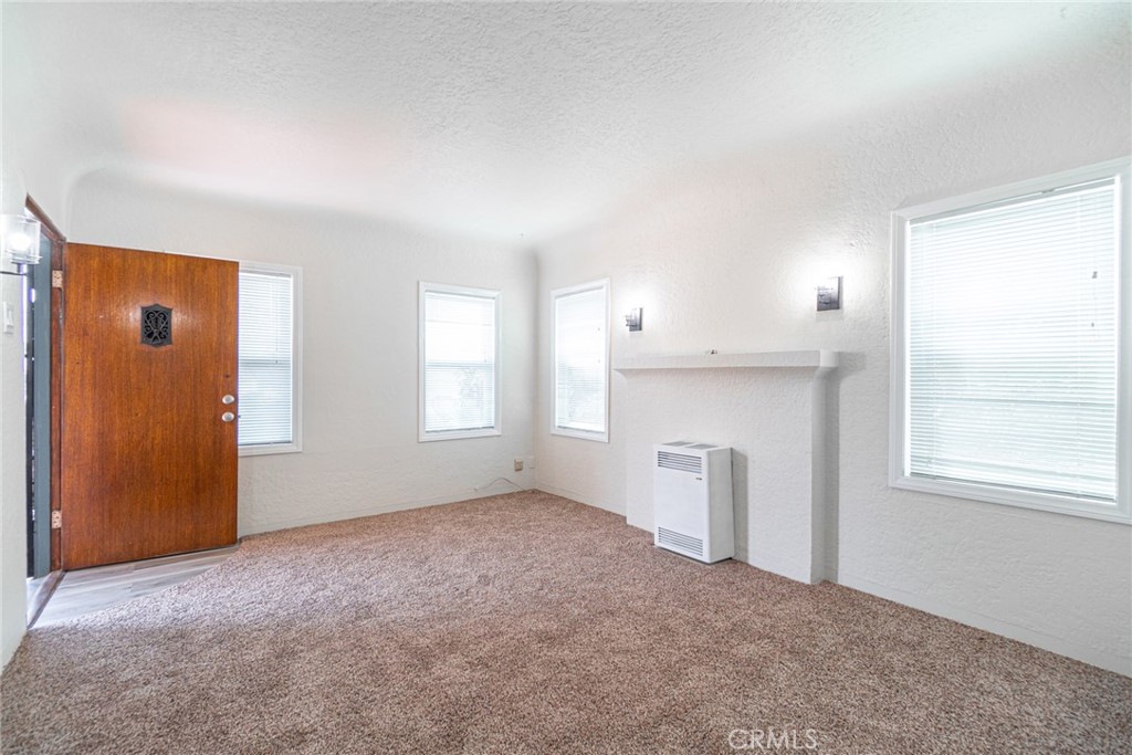 Welcome to this clean and inviting 1 bed, 1 bath Spanish-style apartment located in a well-maintained 4-unit complex on a desirable corner lot. This beautifully updated unit features wall-to-wall carpeting, fresh paint, and a newly renovated kitchen with modern cabinetry. Enjoy classic details like coved ceilings and textured plaster walls that add warmth and character to the living space.The kitchen includes a cozy dining area, and washer/dryer hookups are conveniently located in a private garage. A private 1-car garage is included, with additional street parking available. Ideally located near elementary and high schools, restaurants, and shopping centers.