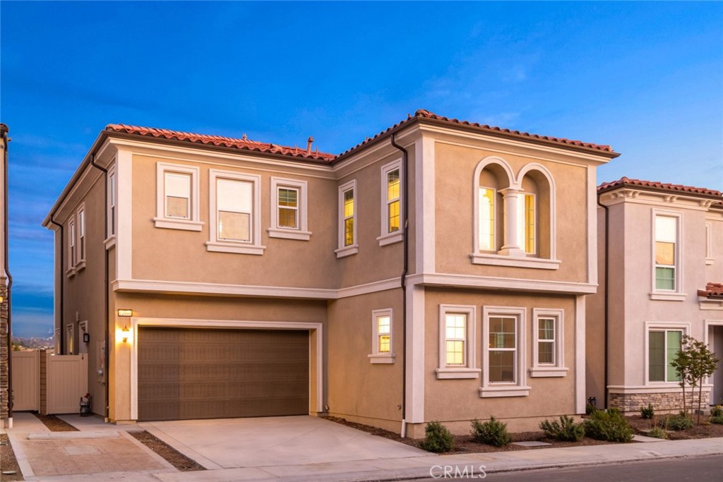 Nestled within the highly acclaimed Walnut Valley Unified School District, this home offers the perfect balance of comfort and sophistication. Thoughtfully designed with premium builder upgrades, it showcases modern finishes and an open layout that elevates everyday living. Expansive windows frame sweeping hillside views, bringing natural light and tranquility into the home. Outside, the professionally landscaped yard creates a welcoming retreat that is both low-maintenance and ideal for entertaining.