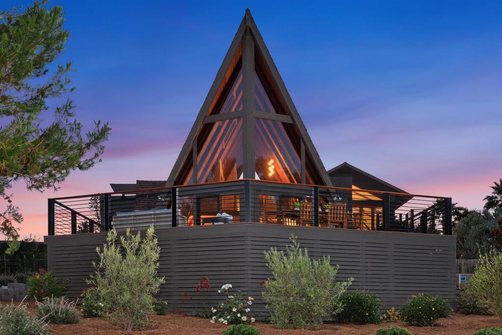 Perched above picturesque Olivenhain, this stunning A-frame retreat offers sweeping views from nearly every room bringing natural beauty into daily living. Set on a private, newly landscaped ½ acre, this reimagined architectural gem perfectly blends rustic character with refined, modern design. Adding even more value is the newly built, and fully permitted, 1bd/1ba 498sq ft ADU ideal for guests, extended family, or rental income. Inside features original wood roof line, expansive windows filling the home with natural light and tranquil views. The airy interior has been thoughtfully updated with all new paint throughout, new doors & hardware, ceramic flooring, wool carpet, and white oak hardwood in the loft & 2 custom modern staircases. A new electric fireplace adds warmth to the living area. The gourmet kitchen is a true showpiece, featuring Thermador appliances, custom walnut cabinetry, Madeirus quartzite countertops, and brass plumbing fixtures. The powder room is elegantly appointed with a Negresco quartzite sink, and the reconfigured primary bath boasts luxurious Tundra Grey marble counters and curated finishes. A newly resurfaced driveway welcomes you home, with pavers adding elegance to the approach. Retaining walls, hardscaping, and a brand-new front electric gate enhance both curb appeal and functionality. Enjoy relaxing evenings from the newly built TimberTech front deck with custom railing, or unwind in the private hot tub beneath the stars. This home captures the essence of Olivenhain living and has both privacy and proximity just minutes from beaches, top-rated schools, parks, shopping and the freeway.