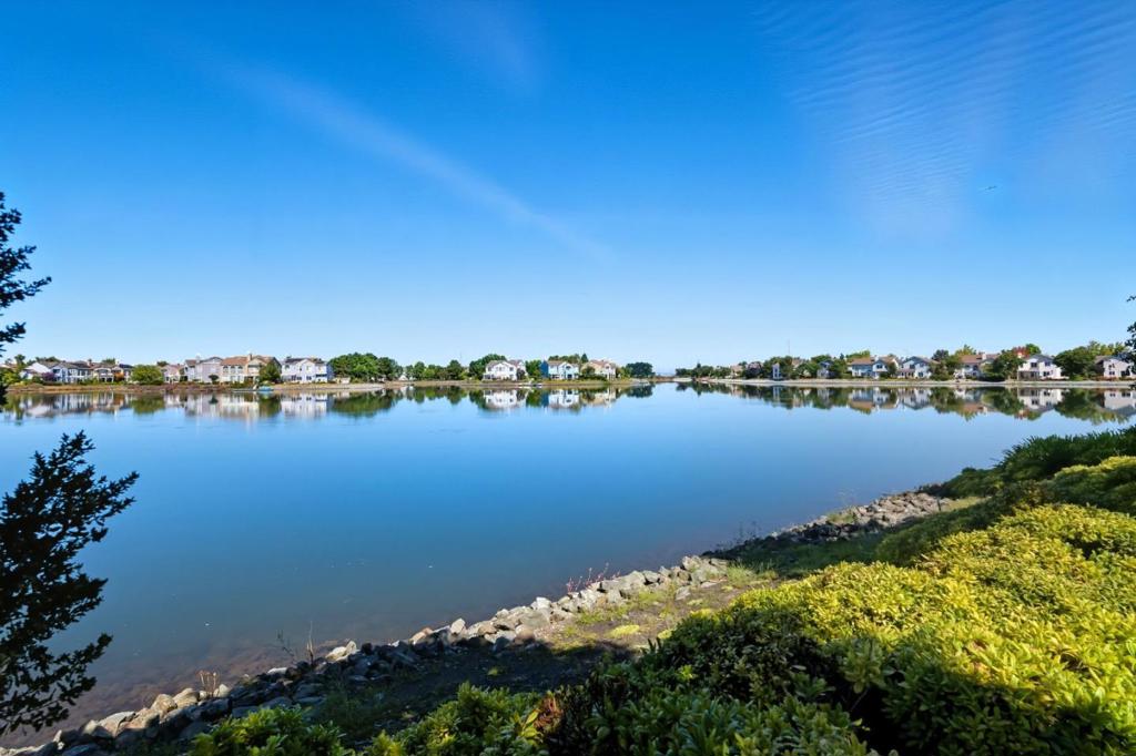 Welcome to this beautifully updated home in picturesque Redwood Shores! This stunning 2-bedroom, 2-bathroom home offers wonderful water views from most living areas and provides you with the convenience of a single level unit and the privacy of an attached garage. Spanning 1,117 square feet, this unit is perfectly situated for those who prefer a stair-free lifestyle. The spacious, open living spaces are complemented by the private patio, perfect for relaxing and entertaining. The recently renovated kitchen features new quartz counters, and a new stainless-steel sink and energy star appliance. The guest bathroom features a new vanity, new lighting, and mirror with new hardware. You'll love the freshly updated primary suite with an enticing patio area, new countertops w/double sinks, new lighting & beautiful new mirrors. This wonderful community also gives you access to excellent amenities, including a pool, spa/hot tub, gym, community center, and gazebo. Ideally located near a big, delightful park, this property is only minutes away from excellent schools, shopping centers, and major commute routes. Experience the perfect blend of tranquility and privacy in this modern, inviting home. Today is the perfect opportunity to buy your very own Home Sweet Home!"