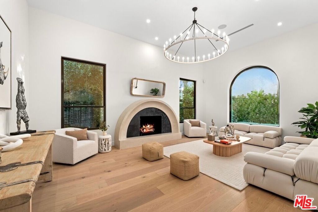 CASA DE LA JOLLA From the moment you enter 100 S La Jolla Ave, it's clear this is no ordinary reconstruction it's a design-forward architectural statement, thoughtfully reimagined to blend natural materials with modern luxury. Featuring 4 ensuite bedrooms, a guest powder room, a heated saltwater pool, and a 2-car garage, the residence offers complete privacy with mature landscaping and a grassy yard ideal for entertaining. Flooded with natural light, the home is exceptionally bright, with sunshine streaming through every room.Inside, soaring ceilings and thoughtfully selected finishes highlight the use of stone, exposed wood, and natural textures. The open-concept kitchen boasts custom Italian leather cabinets, Taj Mahal granite countertops, and all premium Thermador appliances plus wine cooler. Every detail from stone surfaces to natural textures was hand selected to strike the perfect balance between elegance and livability. The primary suite offers dual light-filled walk-in closets and a private patio overlooking the landscaped yard and pool.All just moments from 3rd Street, The Grove, the famous Farmers Market, and LA's best shopping and dining, this home delivers style, privacy, and location in equal measure.