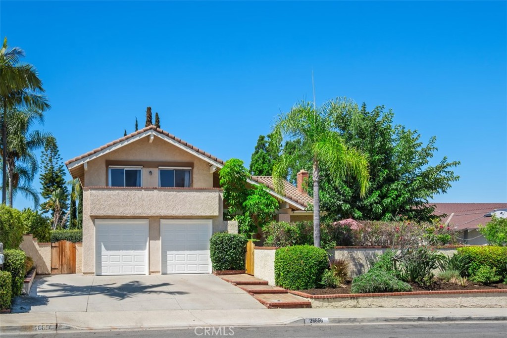 Welcome to 26856 La Sierra Drive –Located in the highly desirable Granda community of South Mission Viejo! This beautifully maintained 5-bedroom, 3-bath home sits on an expansive 7,560 sq ft POOL-SIZE LOT that’s perfect for entertaining and embracing the indoor/outdoor lifestyle SoCal is known for. Step inside through the private, enclosed front courtyard surrounded by lush, mature landscaping—your own serene retreat before even entering the home. Through the double-door entry, you're greeted with soaring vaulted ceilings, a sweeping staircase, and a spacious layout that flows effortlessly from room to room. The living and dining rooms are bright and inviting, complete with a cozy fireplace and sliding glass doors that open to your massive backyard—an entertainer’s dream! Enjoy multiple patios, a large grassy area, peace, privacy, and sunsets through the trees. Whether it's a summer BBQ or relaxing evening under the stars, this yard is ready for it all. The open-concept kitchen features an eat-in nook, step-in pantry, and a full wall of windows overlooking the backyard. It's connected to the family room, which offers a second fireplace and French doors that make outdoor access seamless. Downstairs includes a full bath and a versatile bedroom/office with double-door entry—ideal for guests or multigenerational living. Upstairs, the spacious primary suite offers sliding doors to a private balcony with peaceful views. The ensuite bath includes his-and-hers closets, a walk-in shower, and private water closet. Two additional large bedrooms, a full bath with dual sinks, and a huge bonus room (currently used as a 5th bedroom/suite) complete the second floor. Additional highlights include new HVAC and water heater, storage sheds, and the location is unbeatable! Just steps from Granda Park as well as Sierra Recreation Center—with membership options for the pool, spa, water slide, fitness center, and more. Enjoy Lake Mission Viejo, where you can swim, BBQ, fish, or rent boats and paddleboards. Conveniently situated near Mission Viejo Country Club, shopping, dining, the 5 Freeway and both 73 and 241 toll roads, this home is also just a 10–15 minute drive from world-class destinations like Laguna Beach, Dana Point Harbor, and more! Inquire for more information about MULTIPLE SCHOOL OPTIONS unique to this neighborhood! Welcome Home!