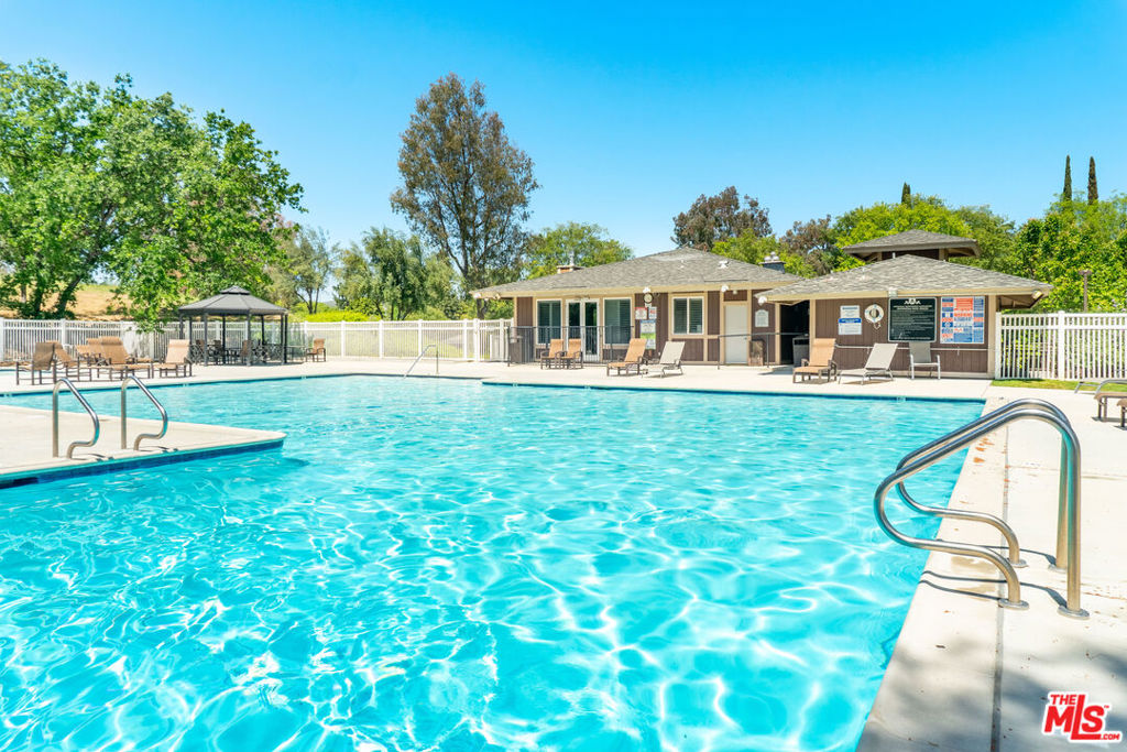 Welcome to a quieter part of town. Enjoy ample green space, tranquil flora and fauna everywhere. Experience Agoura Hills, bike paths, farmers markets, parks, restaurants, and relaxed resort-like living. Designed in a sleek contemporary style, this townhome features newer laminate flooring throughout, enhancing its fresh and modern feel. The bright, open-concept layout seamlessly connects the living and dining areas to the upgraded kitchen, where you'll find crisp clean countertops, a spacious breakfast bar, newer cabinetry, a stainless-steel sink, and sleek stainless-steel appliances. Recessed lighting enhances the home's stylish ambiance. Two generous bedrooms up, offering a large closet, stylishly updated. An in-unit washer and dryer, and an upgraded hall bath with custom tile work. Step outside to the spacious private patio, designed for both privacy and flexibility. 2 patios to allow you to enjoy your view of the lush greenbelt and open common areas, making it the perfect spot to unwind or entertain. A convenient storage closet and a dedicated carport space right next to the unit add to the home's appeal. Located in the award-winning Las Virgenes School District. The Annandale community offers resort-style amenities, including a pool, spa, and clubhouse. This stylish, move-in-ready home offers the perfect blend of modern design, convenience, and location.