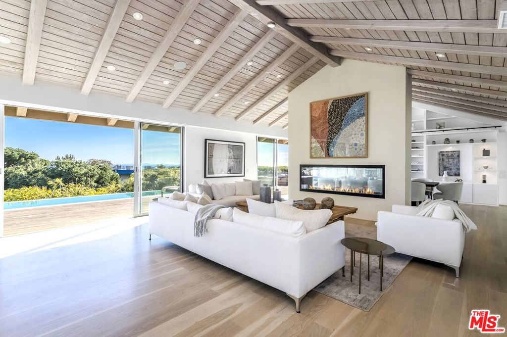 Perched above Westridge Road sits a sophisticated and completely rebuilt mid-century home with the best views in all of Brentwood - a hidden paradise equally suited to soulful relaxation and large-scale entertaining. The single-story open floorplan flows effortlessly through airy public rooms with vaulted wood-clad ceilings. Walls of glass capture inspiring views from downtown to Catalina, and Fleetwood sliders in every room provide seamless transitions to spectacular outdoor areas. Gather with friends at the pool or around the extraordinary outdoor kitchen under a custom pergola with automated shades. A unique cedar-racked wine cave built into the hillside holds over 2000 bottles with full refrigeration and humidity control. Three firepits, from intimate to expansive, punctuate the outdoor entertaining and spa areas, and a Sonos system directs music throughout the home and grounds. Numerous fruit trees dot this magical 1.1-acre property providing a bounty of grapefruits, tangerines, lemons, limes, oranges and pomegranates. Tankless water heater, owned solar panels, solar pool heater, extensive smart-home system, 7-zone HVAC, electric car charger, gated driveway, and private parking for up to a dozen cars complete this exceptional property. Westside indoor-outdoor living doesn't get better than this!