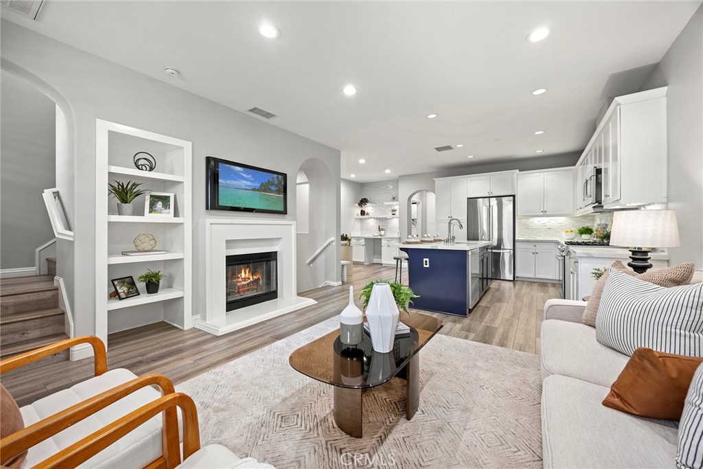 Located within the highly desired community of Colony Park this wonderfully updated four bedroom, four bathroom home perfectly blends sophistication and modern living. Ideally situated directly across from the community greenbelt and playground area this home offers serene views as well as additional privacy. Entering through your private courtyard you are greeted into a main entry that offers you access to a main floor bedroom suite with private bath, laundry room and direct garage access. Ascend the stairs to the main living area of the home that boasts a great room concept living featuring a large kitchen highlighted by with white quartz countertops, shaker cabinetry, tiled backsplash, stainless steel Bosch appliances and a Reverse Osmosis water system. Open to the kitchen is the dining area complete with built-in bar perfect for early morning coffee or evening cocktails and an oversized living room boasting a fireplace and wall of windows with balcony access to enjoy the views. Completing this level is a secondary bedroom and a full hall bath. Upstairs you will find two private bedroom suites including the spacious primary which includes views that overlook the green belt and community with a large walk-in closet and ensuite bathroom including a double vanity, soaking tub and walk-in shower. Not a detail in this home has been overlooked - it is absolute perfection! The Colony Park community offers a Cabana Pool area, Clubhouse, a spacious park and greenbelts, and walking paths throughout. All of this is located a short distance from the Anaheim Packing District, the Muzeo Museum, the historic Mother Colony House, and Pearson Park.