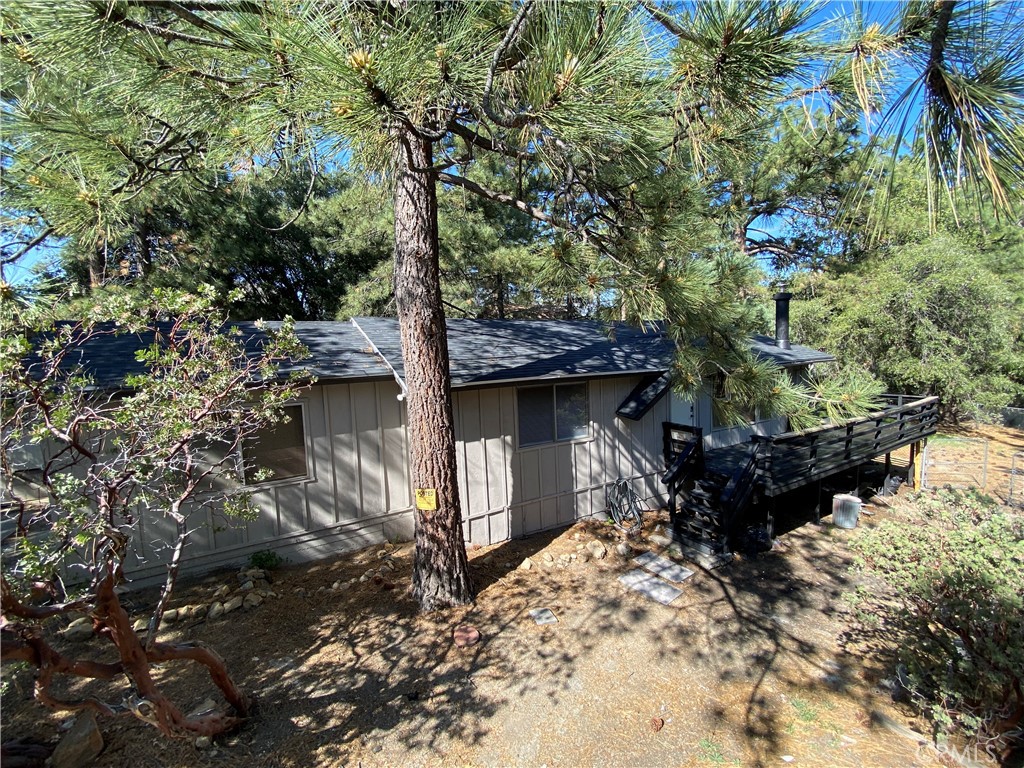 Located Deep off the street on this prime double deep lot with tons of parking in this the highly updated home. Enter into the spacious living room with gorgeous vaulted tongue and groove pine open beam ceilings and picture windows with double-sliders looking into the trees and forest. A cozy corner fireplace competes the room. Gourmet Kitchen with an Island, pull out cabinets, updated kitchen with all stainless steel appliances and high end finishes such as a TECASA sink and faucet. An updated secondary bathroom with a modern vanity finished in white quartz countertops, and a side by side washer and dryer hookups inside the home. Super spacious main bedroom that normally would be seen in a much larger homes complete with double closets and a private bathroom and of course open ceilings. 3rd bedroom is a bonus room with closet, makes for a perfect bunk room, office, retreat, art room or baby nursery. A very large deck area that wraps around the entire back and a good portion of the front of the home overlooking the spacious backyard with a large estimated to be 70-100+ years old black oak tree. All of this is within walking distance to some of the best trails and off map mountain biking. The Driveway can easily fit a large RV, the street is plowed when it snows for easy access year round! You will not be disappointed in this home! Comes lightly furnished complete with pots and pans, coffee maker, air fryer etc.