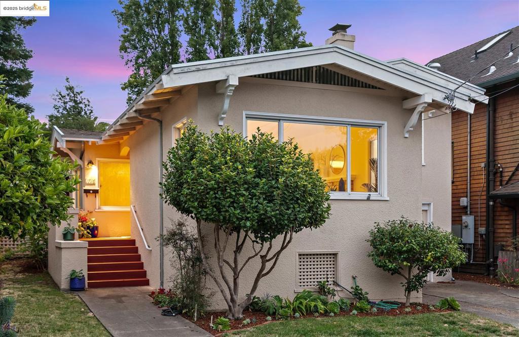 Built in 1924 and lovingly cared for by one family for 7 decades, this traditional home sits on a sunny lot lined with birds of paradise, orchids, and fruit trees—including apricot, apple, and persimmon. A private entry opens to a warm living and dining area, accented by a paneled wall. The functional kitchen, ready for your creative updates, features large sliding doors that open to the expansive backyard, perfect for outdoor dining and gardening. A unique hallway with a clerestory window separates the public and private spaces, leading to two bedrooms and a full bath. Downstairs, “Betsy’s Room” offers a flexible bonus space with a half bath, closet, and direct yard access—an ideal office, guest room, or creative studio. A single-car garage and driveway provide convenient parking for two. Nestled on a quiet street of rolling hills, this home is a short 7-minute walk to North Berkeley BART, the shops and restaurants of North Shattuck, and the evolving University Avenue district anchored by Trader Joe’s. One mile from Solano Avenue, you’re perfectly positioned for neighborhood events like the annual Solano Stroll—park here and enjoy the walk! This well-loved home blends quiet living with vibrant urban access, offering a rare opportunity to create your Berkeley dream.
