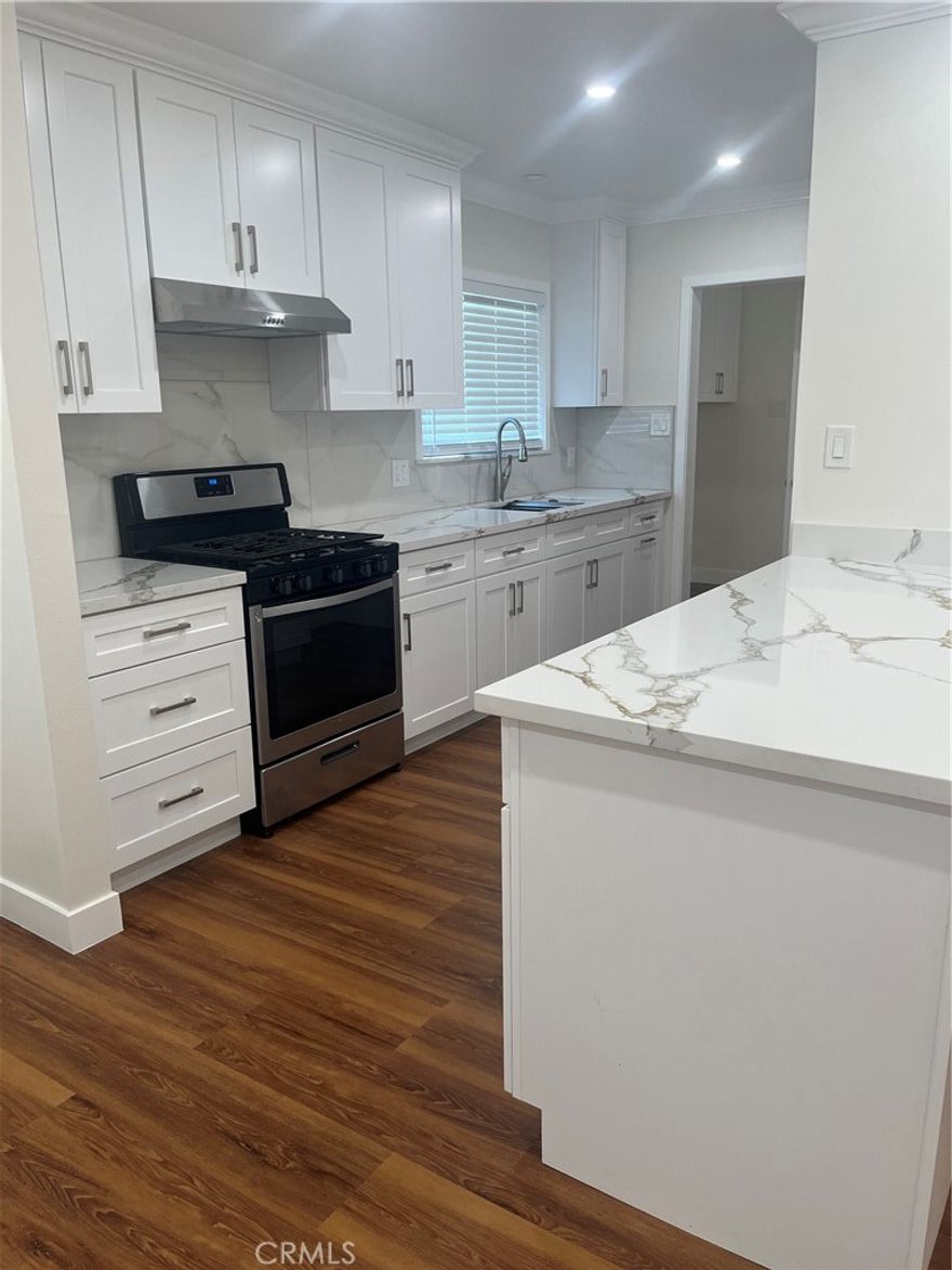 This is a beautiful remodeled home.  It is like a brand new home in a highly desirable area.  You are close to great schools, Frwy. Access and transportation. Large open floor plan with a living room making a great room with nice wood floors, wide baseboards and crown moldings.  Scraped ceilings, recessed lighting, new windows, horizontal faux style blinds and ceiling fan.  The kitchen has white quartz counters and lots of shaker cabinetry, farm stainless steel sink and brand new gas range.  The laundry room is an individual room with extra storage cabinets and access to the rear yard and convenient bath.  Four good sized bedrooms with wood flooring, large baseboards, recessed lighting, ceiling fans, mirrored wardrobes, and new windows with horizontal wood faux blinds.  One bedroom is specifically designed to be used as an office or infant room with closet and barn doors into the master bedroom.  Three baths with both shower over tub and a large walk in shower in the master suite.  The attached double car garage has lots of built in cabinets.The hardscaping and beautiful plants add to the curb appeal of this wonderful home.  The rear yard is secure with a brick block wall, large grass area and newly poured slab patio.  Lots of room to spread out and just enjoy life!