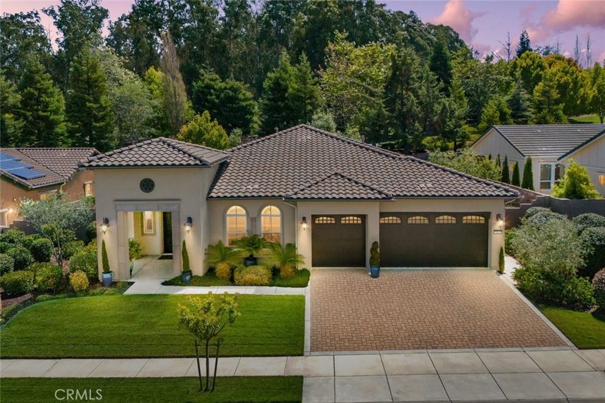 Welcome to Trilogy living in this beautiful Morro Estate home with a striking portico entrance, located just steps from the clubhouse with all the fabulous activities that make Trilogy such a wonderful place to live. Step inside the spacious foyer of this 2,760 sq. ft. 2 bedroom, 2.5 bath, plus den, home and you’ll discover an entertainer’s paradise. The open-concept floor plan features a living room and dining room divided with a double-sided fireplace, with an adjacent family room and a gourmet chef’s kitchen. This majestic home is loaded with designer upgrades, including engineered wood floors, granite countertops and plantation shutters, plus it has a super large den and a custom-built wine room with two chillers and a spirits bar. Head towards the centrally-located kitchen which features a large radius island with pendant lighting, rich raised-panel cabinetry, GE Monogram stainless steel appliances including a gas cooktop, wall oven and microwave, Bosch refrigerator and a walk-in pantry. A French door leads to the backyard which has been transformed into an oasis with impeccably-designed professional landscaping, maintenance-free pavers and a rock water feature - you’ll spend many hours relaxing in this beautiful, private setting. Evenings are a special treat in your primary suite - an oversized bedroom with a dedicated sitting area complete with a corner fireplace, plus a luxurious master bath with a soaking tub, separate dual sinks, tile shower with seamless glass enclosure, linen storage and a spacious walk-in closet - it’s a spa-like retreat just waiting for you. Your overnight guests will feel right at home in their own separate wing featuring a light and airy bedroom with full bath right next door. In addition, there’s a powder room, laundry with sink and a custom “drop zone” for keeping coats, hats and shoes easily accessible. Completing this gorgeous home is a highly sought-after 3-car garage, energy-efficient solar and A/C. Best of all, this beautiful home is located in Trilogy Monarch Dunes with resort-style amenities including Adelina’s Bistro, Sandalwood Spa, fitness center, art studio, pickleball courts, and world-class golf.