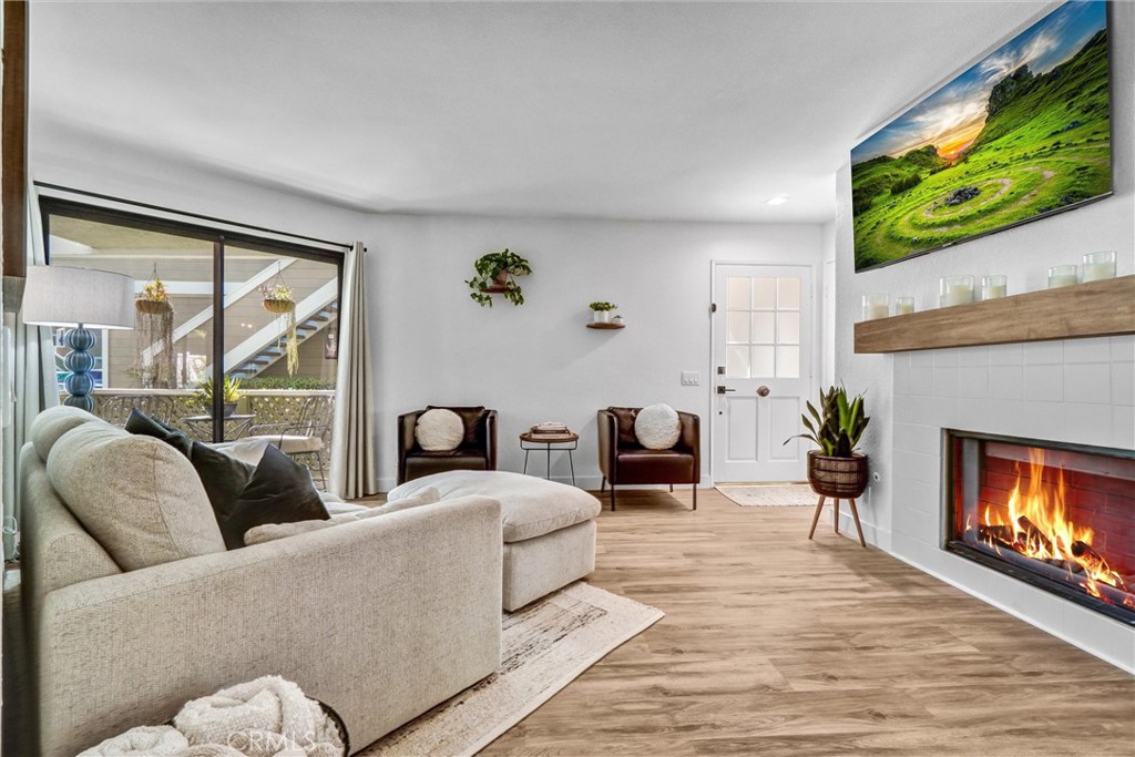 Come ENJOY 15 Abbey Lane in the Heather Ridge development within WONDERFUL Aliso Viejo! Located only 8 miles from world-famous Laguna Beach! This is an AMAZING 1ST Floor townhome-style unit with 2 big bedrooms, 2 bathrooms, and a host of UPGRADED features! These include New water softener system, Remodeled primary and guest bathrooms, Upgraded Fireplace in spacious Living Room, New garage storage racks, New Soft-close hinges installed on all kitchen cabinets, AC unit fully serviced 3 months ago, Remodeled and Updated Large Backyard landscape with maintenance-free turf, Mature Peach tree in backyard, and a 7 minute walk on paved walking trail to shopping center with grocery, restaurants, & coffee shops. There is access to the Community Pool, 2 community hot tubs, and tennis courts! The Monthly HOA fee covers your water + trash bills. This home has been thoughtfully updated with new paint and flooring throughout. It shouts PURE ELEGANCE when you see it! This is an END UNIT with a very Spacious Private Patio great for relaxing or entertaining. The location is Private and so RELAXING! Interior laundry area and The Primary Bedroom is a sanctuary with direct access to the private patio. It boasts a walk-in closet and ample storage for all your belongings. The secondary bedroom also offers its own private patio, providing a personal outdoor space for relaxation or quiet contemplation. It's the perfect spot to enjoy a morning coffee or unwind after a long day. Situated in Aliso Viejo, this HOME offers a prime location with easy access to shopping, dining, and entertainment options. Enjoy the convenience of nearby parks, trails, and recreational facilities, allowing you to embrace your desired lifestyle. There is also a 1 car garage with storage racks and water hose access. FHA approved project! Don't miss the opportunity to make 15 Abbey Lane your new home!