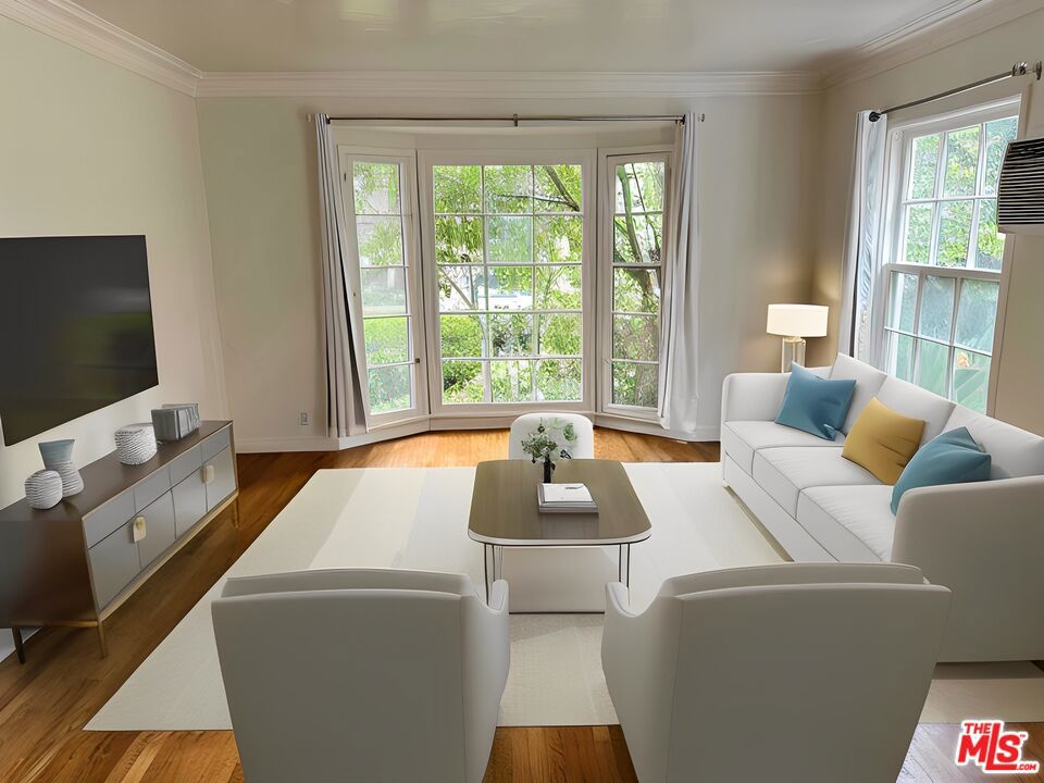 AVAILABLE NOW! This elegant, front-facing corner residence showcases beautiful French bay windows framing serene street and garden views. The sun-lit kitchen blends modern finishes with functionality, while rich hardwood floors flow throughout the flowing interior. The spacious primary suite offers a walk-in closet, complemented by two hallway linen closets for exceptional storage. Perfectly situated in the heart of Beverly Hills, this home offers unbeatable walkability to world-class shops, dining, and neighborhood conveniences.