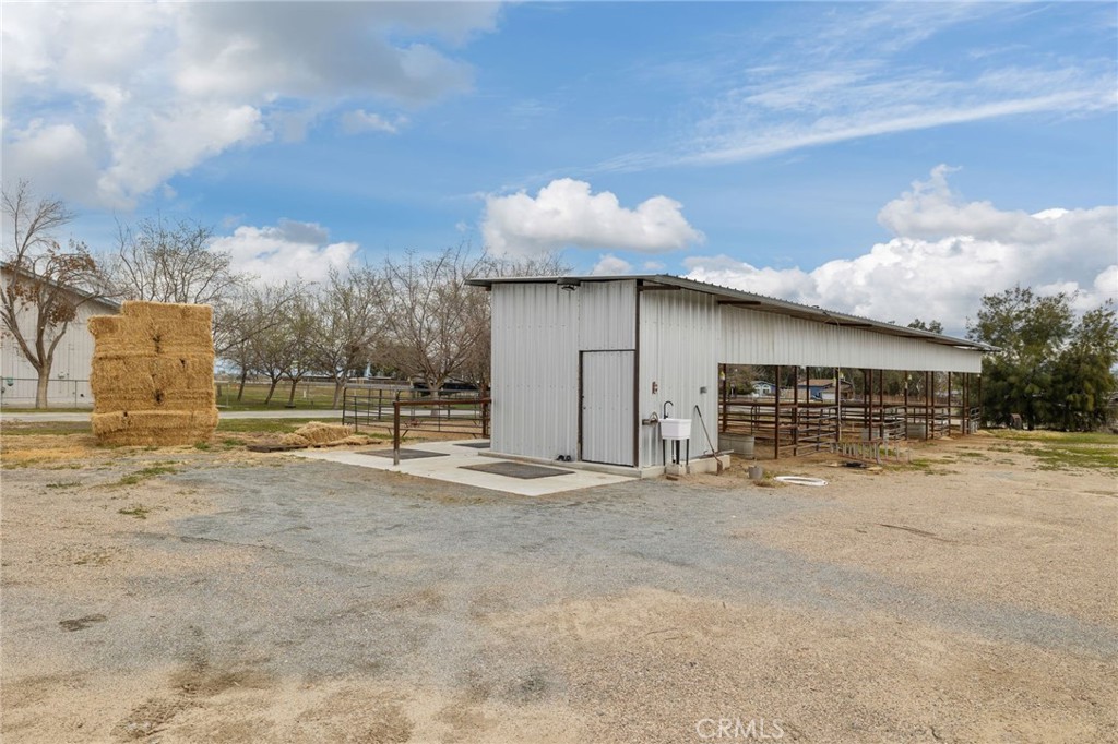 Looking for multi-family living, rental income, and horse property all on one lot? This 2.77-acre estate checks every box with two homes and room to possibly add a third. The main residence boasts modern upgrades including 88 OWNED solar panels, newer HVAC, and copper plumbing. At its heart is a gourmet kitchen featuring commercial-grade appliances, copper farmhouse sink, oversized butler’s pantry, plus separate walk-in refrigerator and freezer. With two primary suites, additional bedrooms, and a massive laundry room, the layout is ideal for multi-gen living or frequent guests. Outdoors, enjoy equestrian facilities with stalls, auto waterers, and plenty of space to expand, along with three RV hookups and a dump station. A separate manufactured home adds even more value—perfect for extended family, guests, or rental income. With more upgrades than we can list here, be sure to ask your Realtor for the full 3-page upgrade sheet—you won’t believe all this property offers.