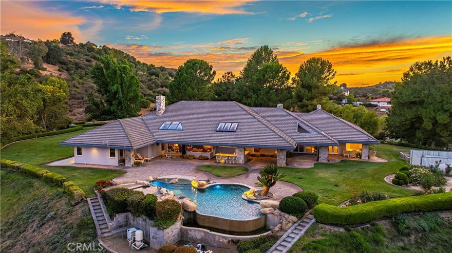 Welcome to La Cresta where this amenity-rich equestrian estate is available for the first time ever. The main house spans roughly 5,000 square feet within a sprawling floor plan designed with soaring ceilings and high end finishes at every turn. Enjoy open concept living with panoramic seamless glass windows that bring incredible views into nearly every room of the house. The massive gourmet kitchen offers a breakfast bar, center island with a prep sink and ice maker, double ovens, and a large walk in pantry with another prep sink. There is plenty of room for family and guests with separate family and living rooms, a formal dining room, and four bedrooms, five bathrooms and a library. The backyard is an entertainer's dream with an infinity edge swimming pool, jacuzzi, barbecue, sink, poolside bathroom, and again, those incredible views. While the main house offers an oversized three car garage, after a quick walk down to the barn you’ll find an additional four car garage along with a massive pull through RV garage. In the breezeway of the barn you’ll find a large tack room, feed room, wash racks and four horse stalls. The entire second level of the barn is a large two bedroom one bathroom guest house that also offers incredible views, with a studio apartment adjacent to the garage down below. At the west end of the property the equestrian amenities continue with a large arena and two fully fenced grass turn outs. Move right in with confidence knowing that this home has everything you need to live comfortably with a garden, fruit trees, solar power, back up generator, city water connection, two wells, two water storage tanks, and hard wired security camera system. Schedule a private showing today and seize the rare opportunity to own this fine equestrian estate.