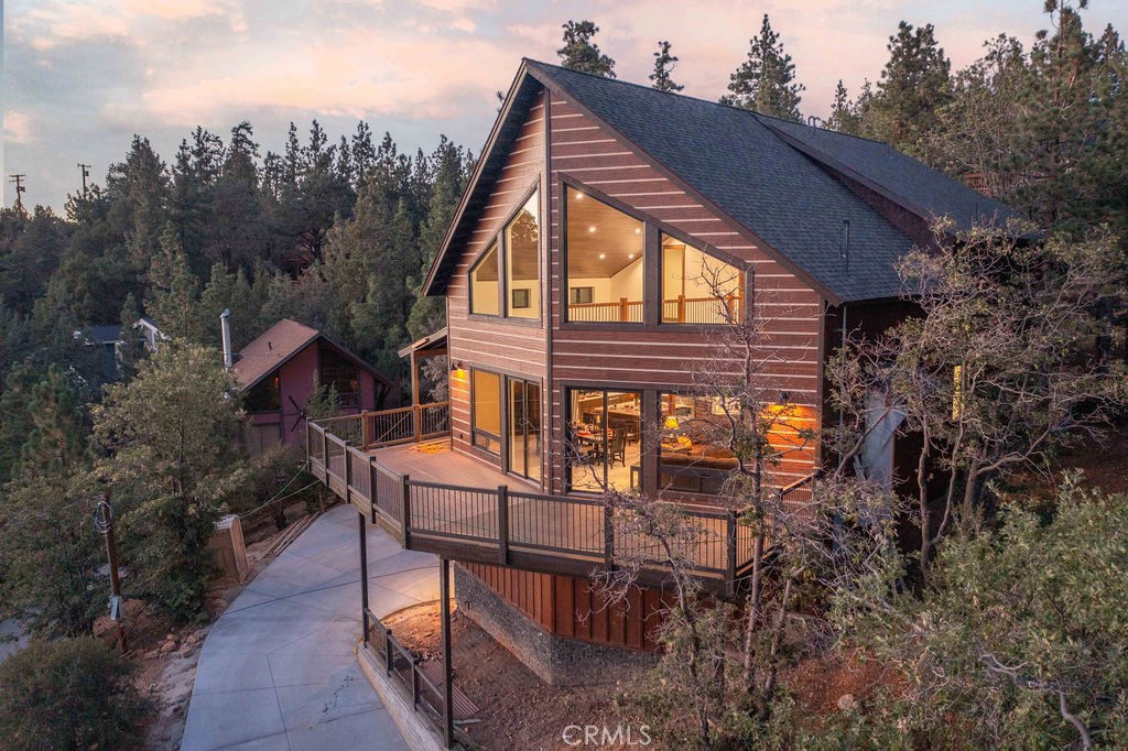 Welcome to "Mountain View Chalet," your ultimate luxury mountain retreat! This stunning newer build combines exceptional quality with unparalleled comfort, creating the perfect backdrop for unforgettable memories.
Step inside this expansive five-bedroom sanctuary, where a breathtaking two-story living area awaits. The magnificent wall of windows not only floods the space with natural light but also frames the stunning mountain vistas, offering a serene setting to unwind and soak in the beauty of nature from your own home.
With over 3,000 square feet of thoughtfully crafted living space, every detail is designed to provide a fresh and inviting atmosphere. The open layout effortlessly connects the living area to a beautifully equipped kitchen, ideal for whipping up meals and entertaining loved ones.
Step outside to discover a world of possibilities. Whether you're savoring the crisp mountain air from the deck or embarking on adventures along nearby trails, this haven embraces a lifestyle brimming with relaxation and adventure.
This is the perfect launchpad for everything Big Bear has to offer!