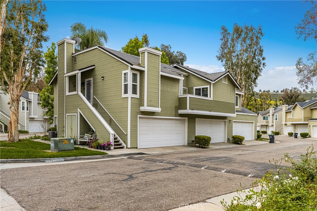 Tucked away in the peaceful canyons and surrounded by lush trees, this beautiful upstairs, renovated 2-bedroom, 2 bathroom condo in Yorba Linda Villages offers the perfect mix of modern comfort. This spacious layout, is an end unit that let's in tons of light and creates a brite and airy vibe! The remodeled kitchen has a newer gas stove and microwave, pull out drawers in the cabinets with an opening to enjoy a view of your patio balcony. From your living room step out to your private patio balcony to relax and enjoy the fresh air and sunshine. The living room has a cozy gas fireplace, crown moldings and custom paint. Heading down the hallway is a very cute window seating area to again, enjoy the patio balcony. The first bedroom boasts a 3 door oversized closet, window blinds, ceiling fan and laminate flooring. The hall bath has a tub/shower and has been remodeled. The large primary bedroom with crown molding, custom shutters, ceiling fan, laminate flooring and a large walk in closet. The primary bathroom remodeled with a separate toilet room and a large walk in shower. The home has been updated with style and thoughtfulness to ensure a comfortable living space. In this quite community you can enjoy the sparkling pool, spa, clubhouse and tot lot area. Located next to walking trails, Santa Ana River Trail for biking and walking. Yorba Linda award winning school district. Plus, a detached 2-car garage with plenty of storage cabinets and parking. This condo is the ideal retreat for anyone looking to enjoy a peaceful lifestyle with easy access to nature and all the comforts of modern living!