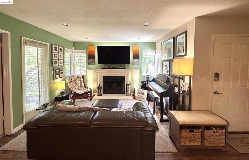 Rarely available two-bedroom, two-bathroom unit on the second floor of Raintree Terrace Condominiums. It features a balcony and over 860 square feet of living space. This charming and functional unit shows exceptional pride of ownership with numerous features and updates, including a wood-burning fireplace, a new stackable washer and dryer, granite countertops, and stainless steel appliances. For added convenience and modern living, it also boasts a Nest keyless entry system and verbal HVAC control, and each room is wired to meet modern AV standards. Both bedrooms offer en-suite bathrooms and ample closet space. The living area includes a convenient eating counter, and the balcony is perfect for enjoying the afternoon sun. The pet-friendly community is set within a park-like environment with walking paths. Residents also have access to a workout facility, spa, and a sparkling pool. This unit includes a covered parking space, and the location offers easy access to shopping and the freeway, making it an ideal Bay Area home base.